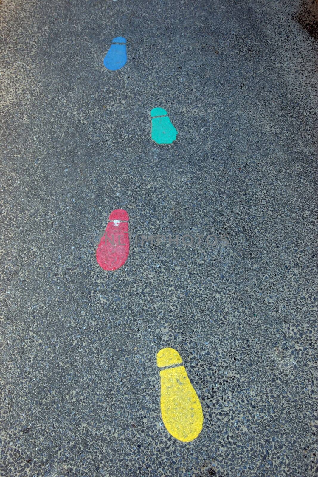 painted footprints on tarmac in infant school playground