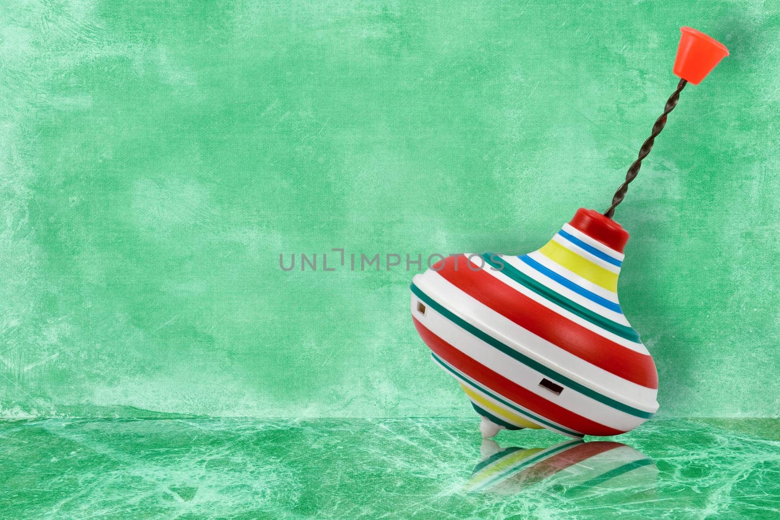 whirligig toy with reflection on blue background