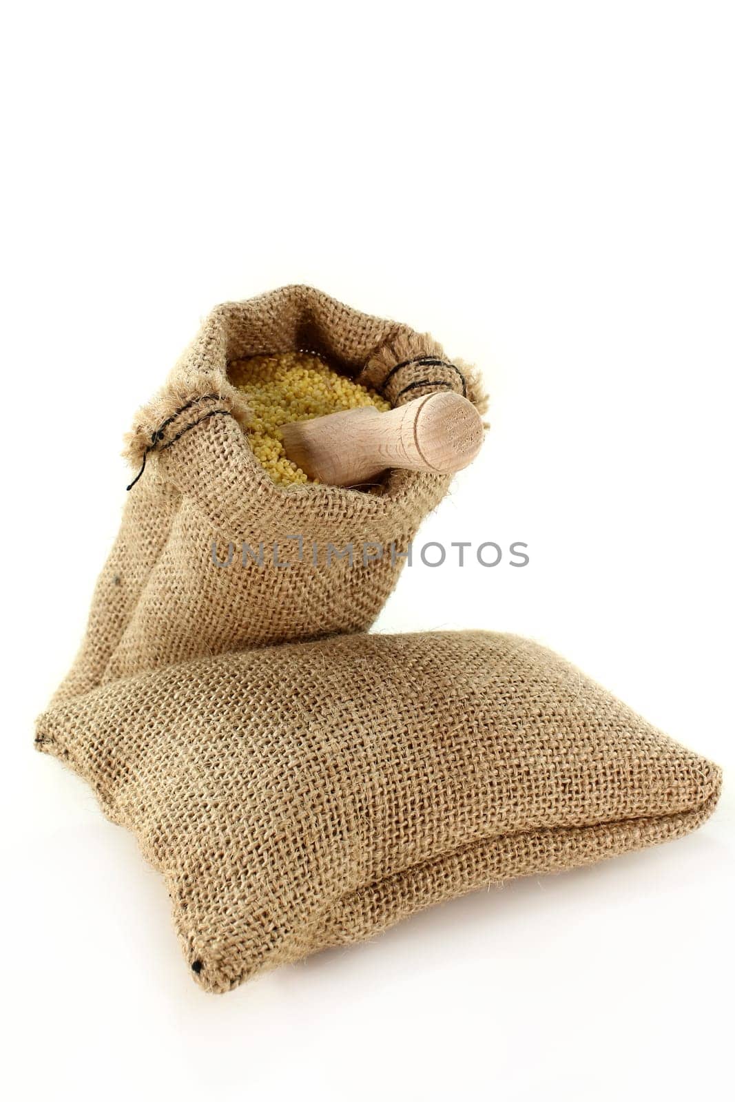a sack filled with millet against a light background