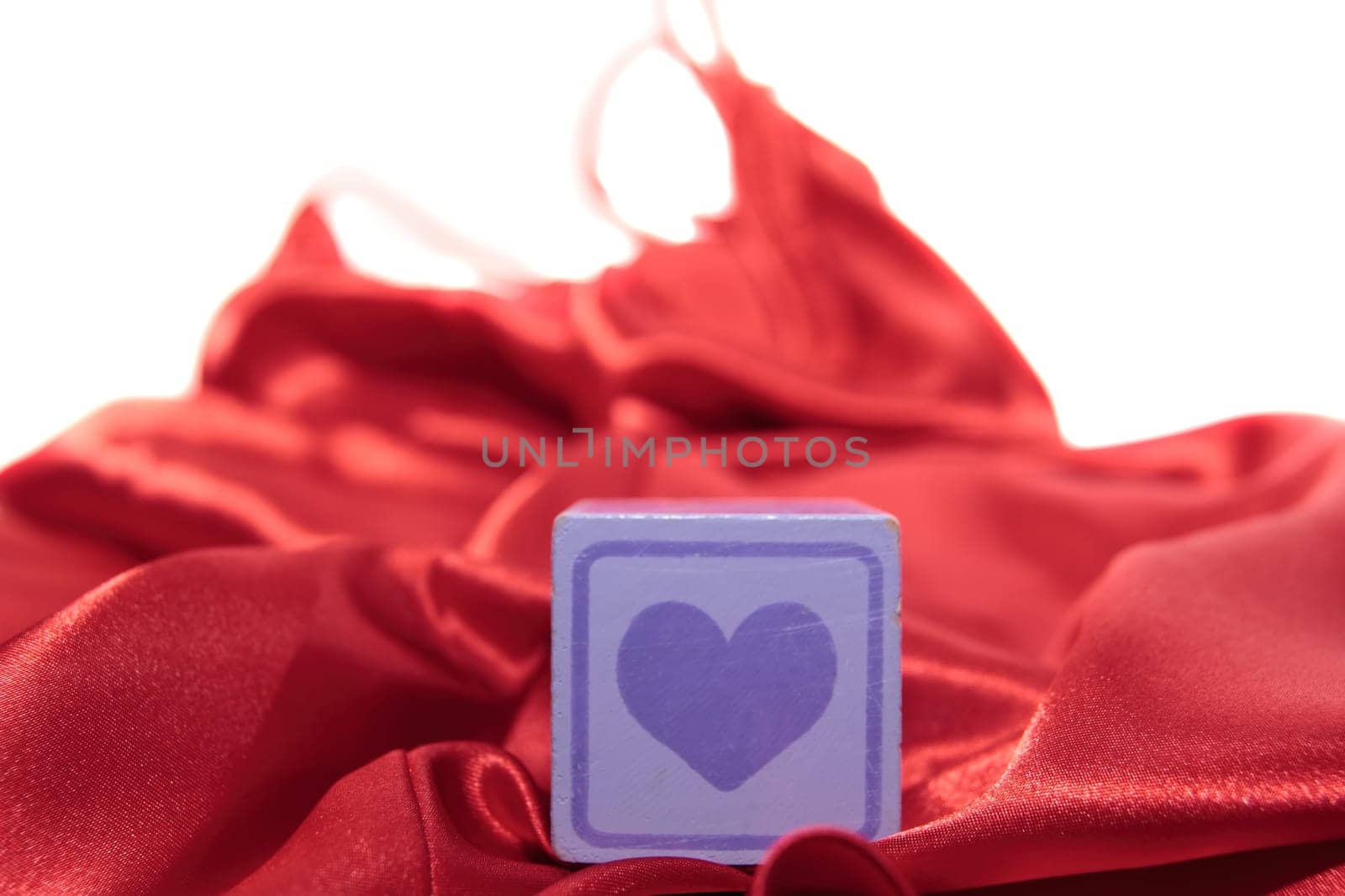 love heart on block on a silk nightie against white background