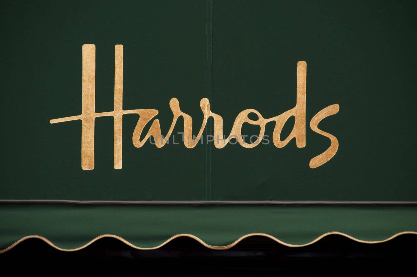 Harrods golden sign on green awning