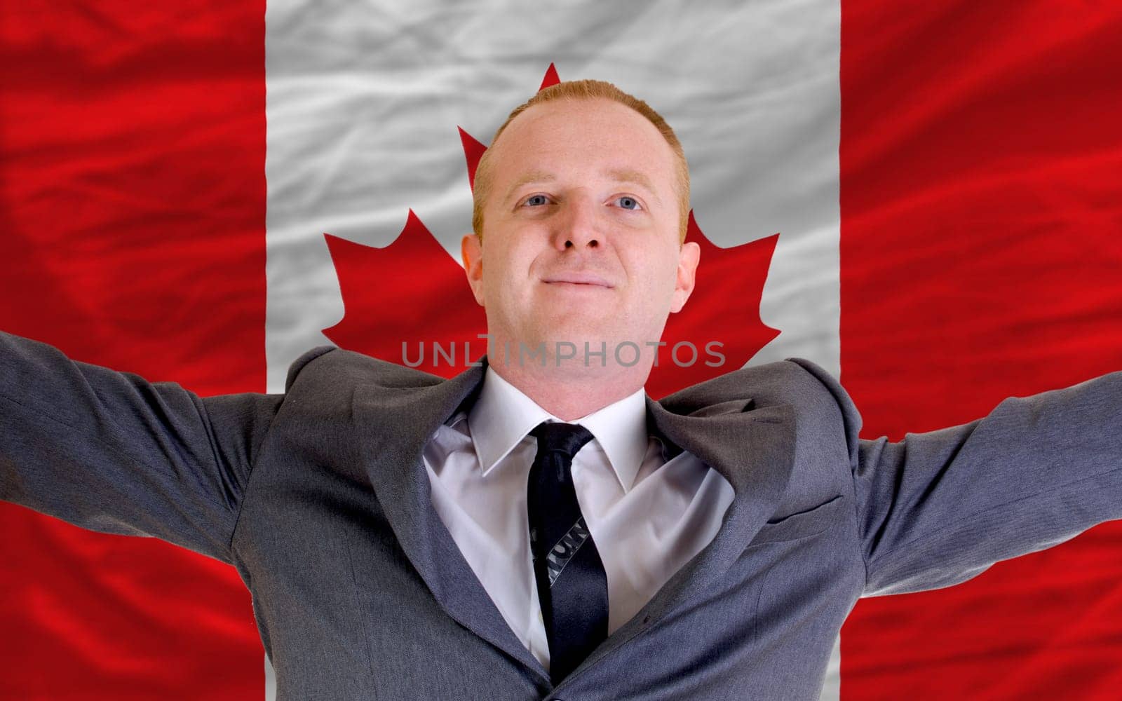 joyful investor spreading arms after good business investment in canada, in front of flag