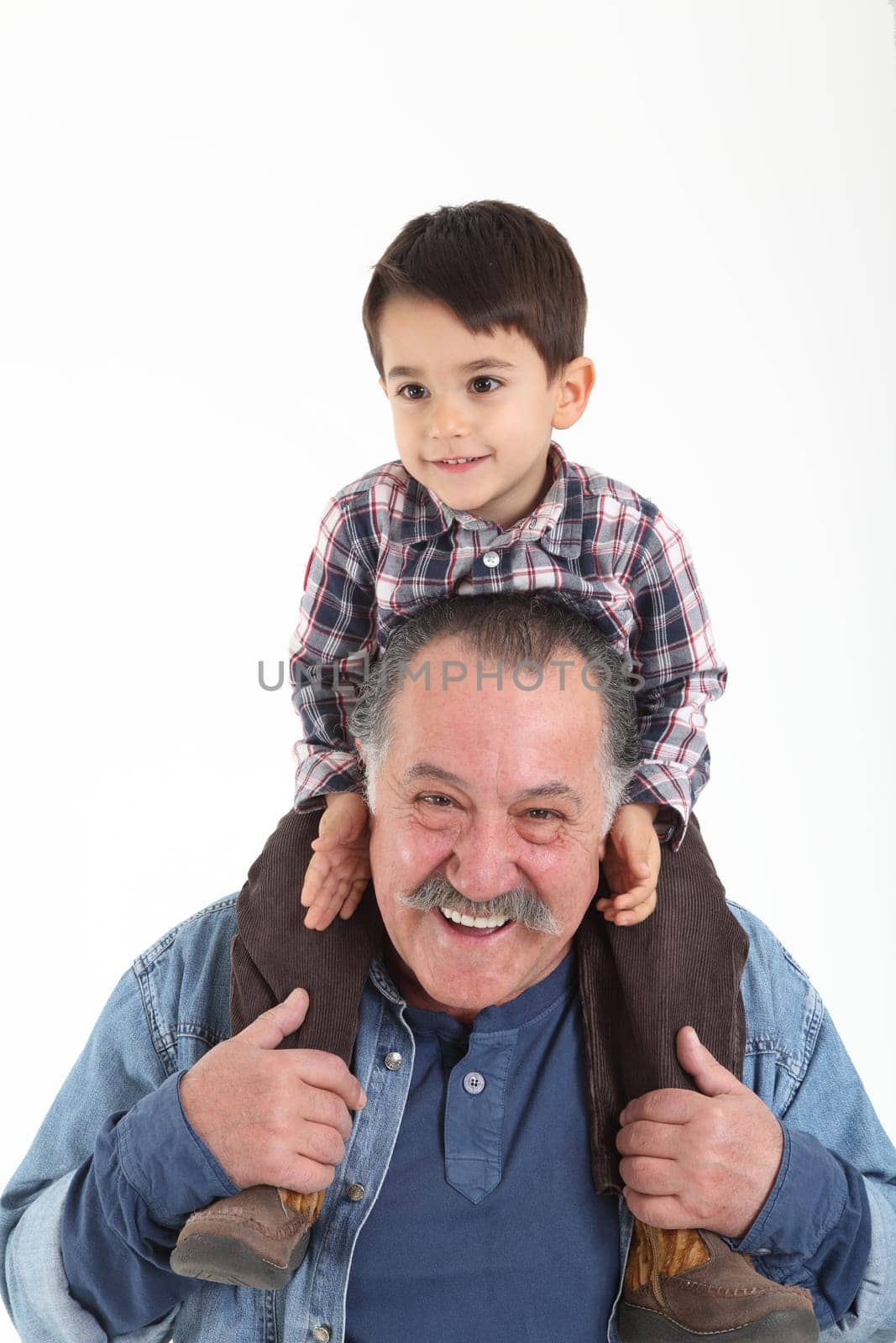 Child and grandfather stay together on white background