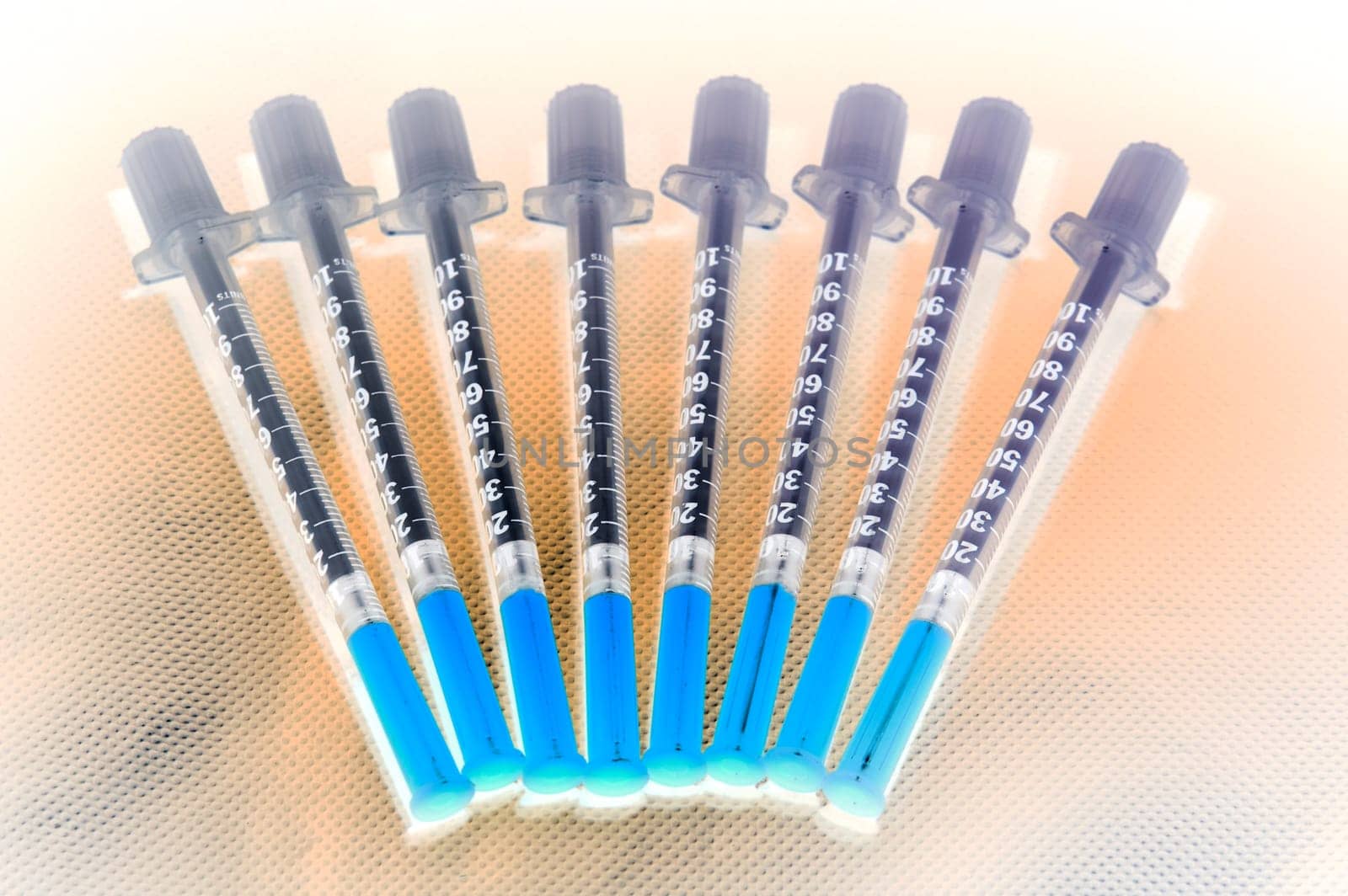 Shaded insulin injection pen laying on studio ground