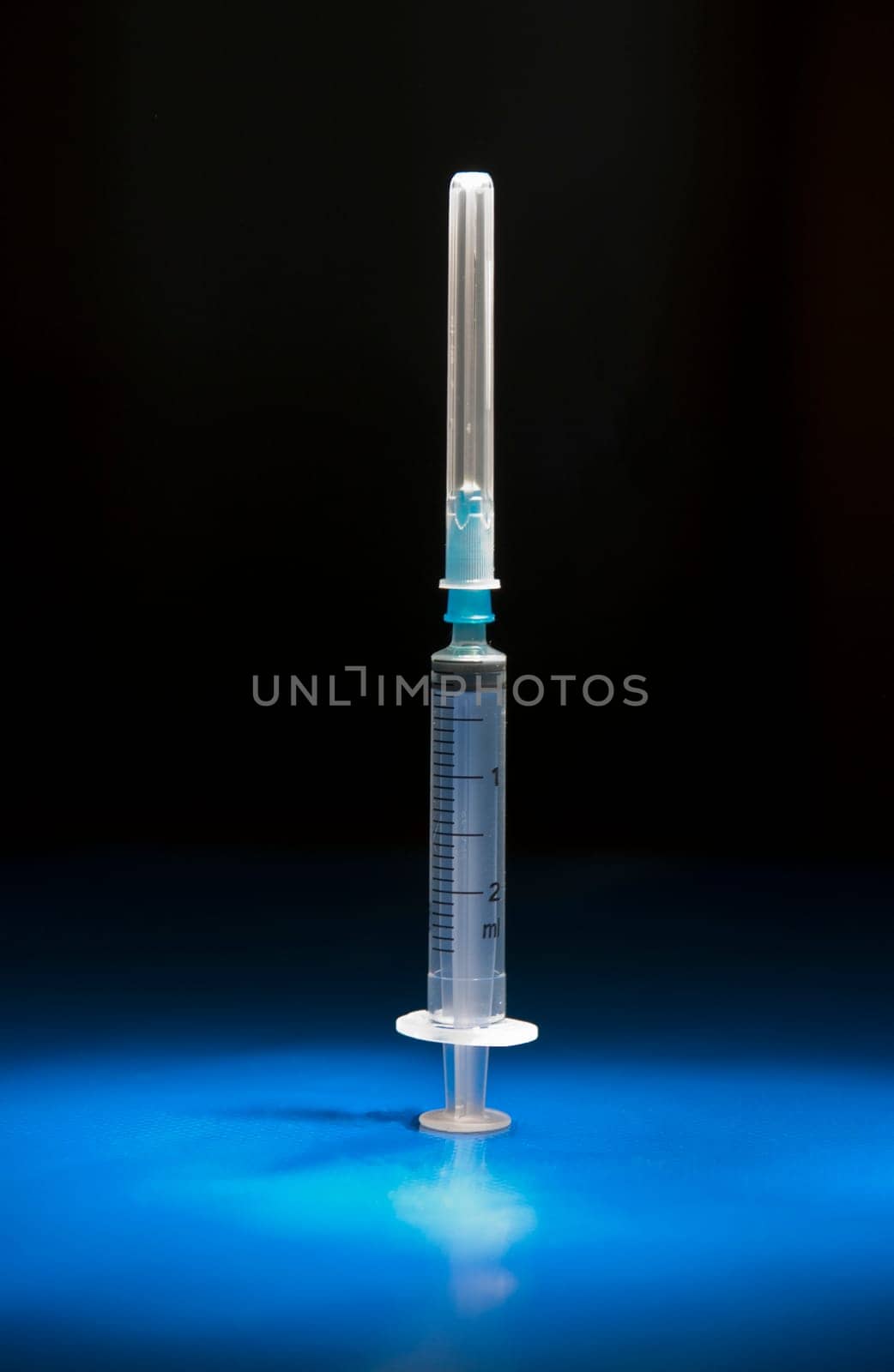 Empty and isolated medical syringe standing head up