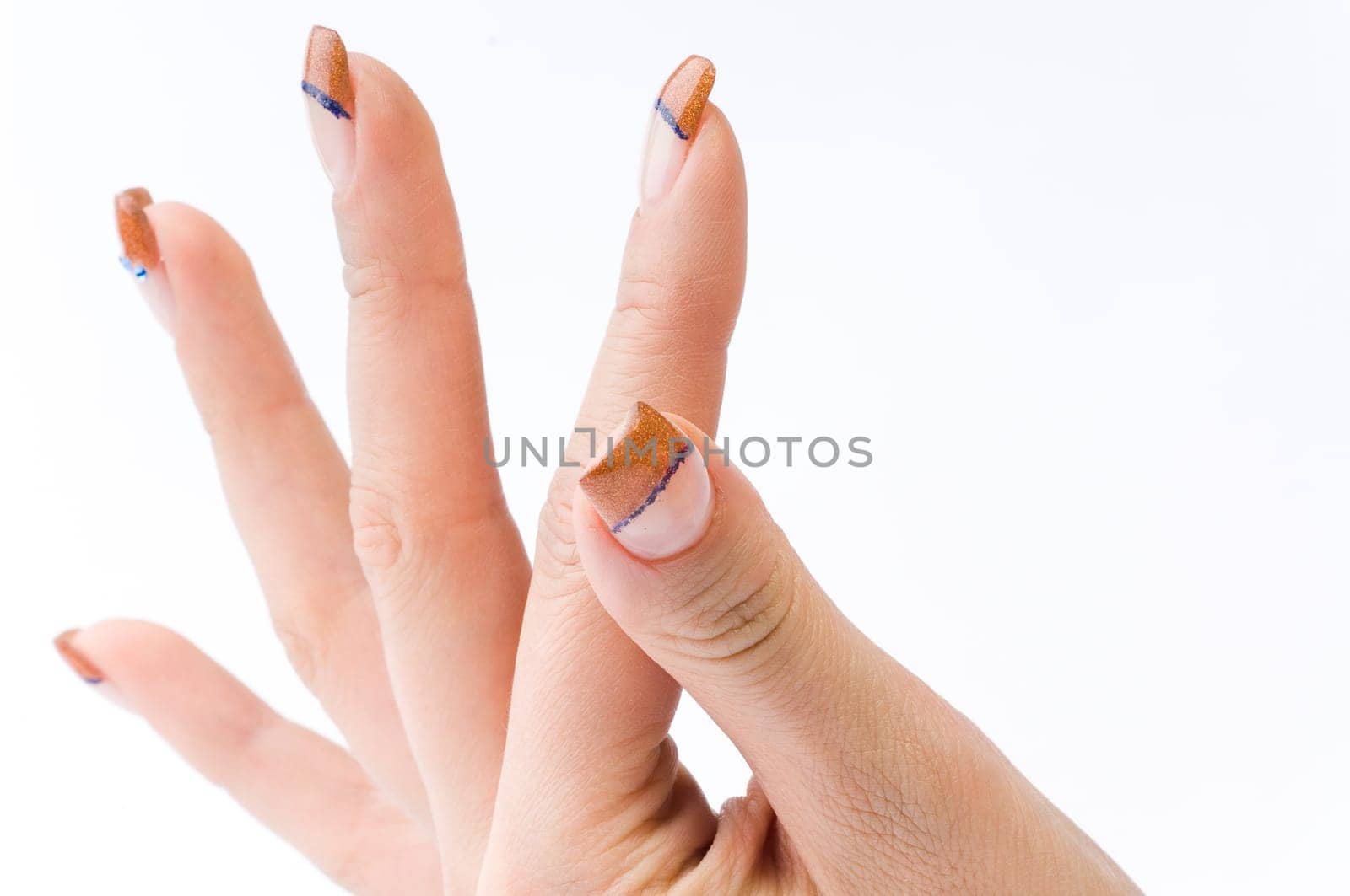Beautiful female well-groomed colorful fingernails against white background