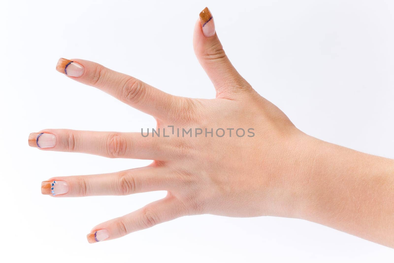 Beautiful female well-groomed colorful fingernails against white background