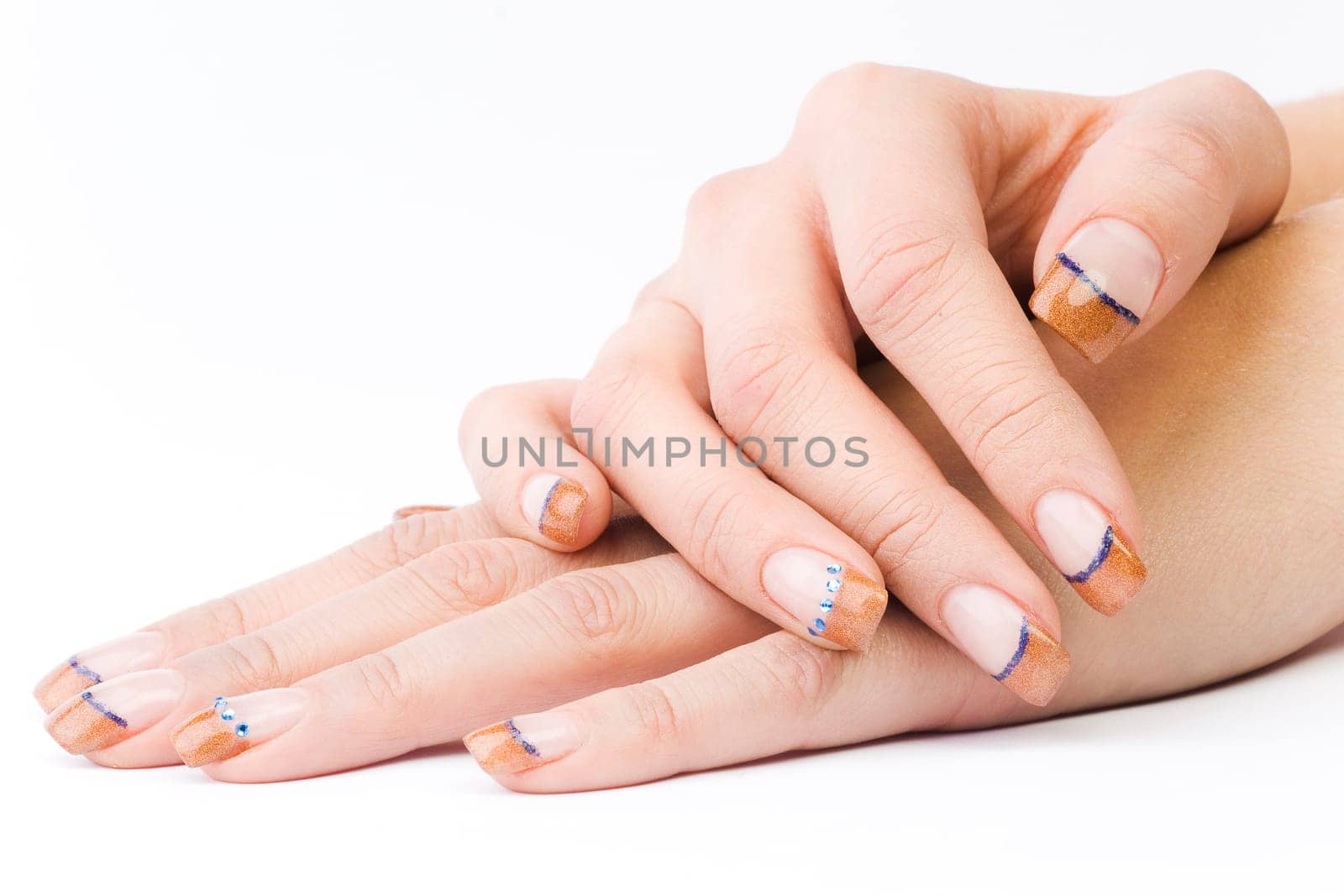 Beautiful female well-groomed colorful fingernails against white background