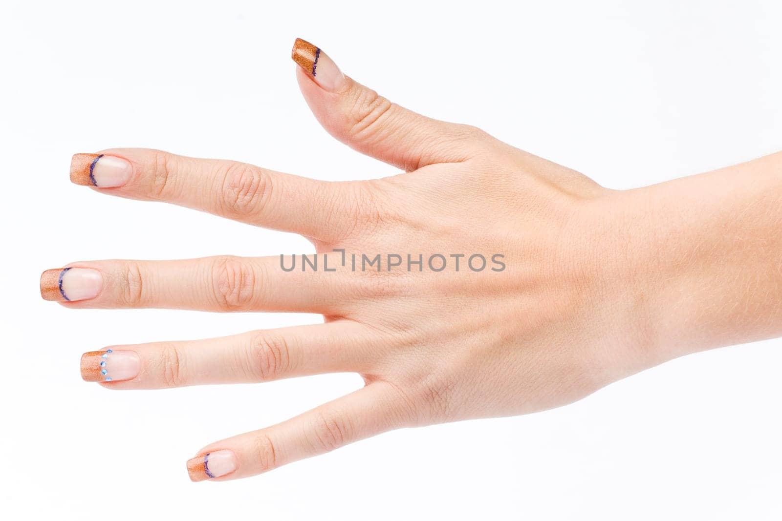 Beautiful female well-groomed colorful fingernails against white background