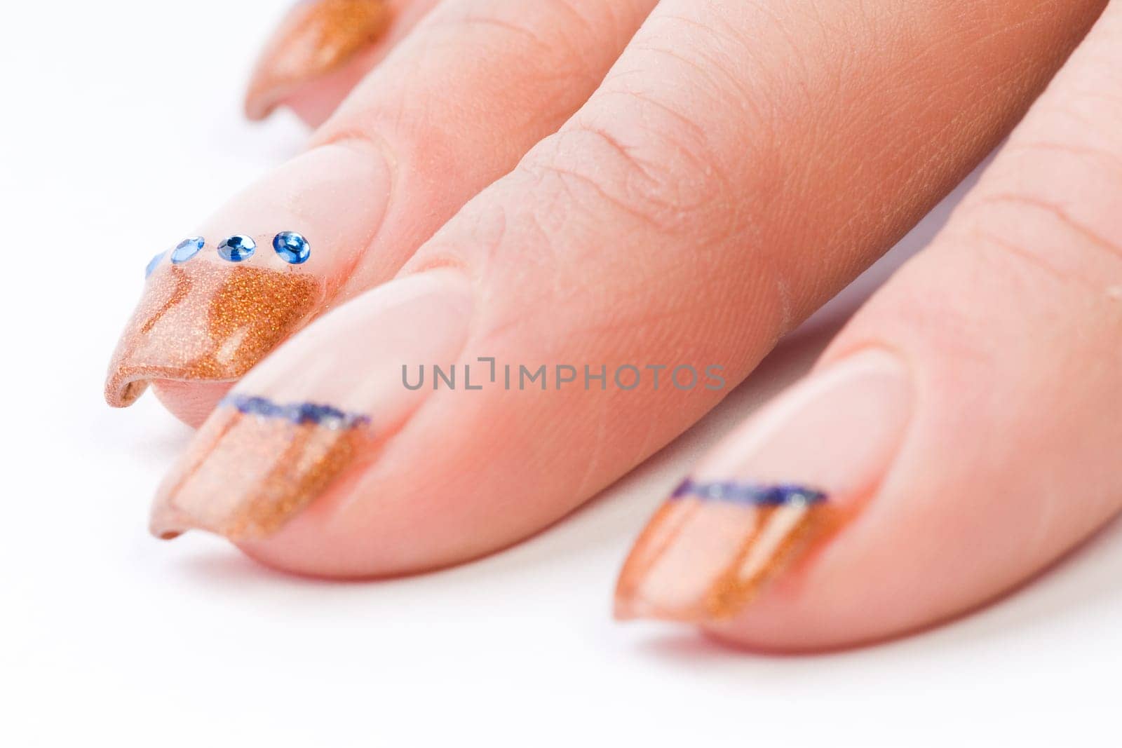 Beautiful female well-groomed colorful fingernails against white background