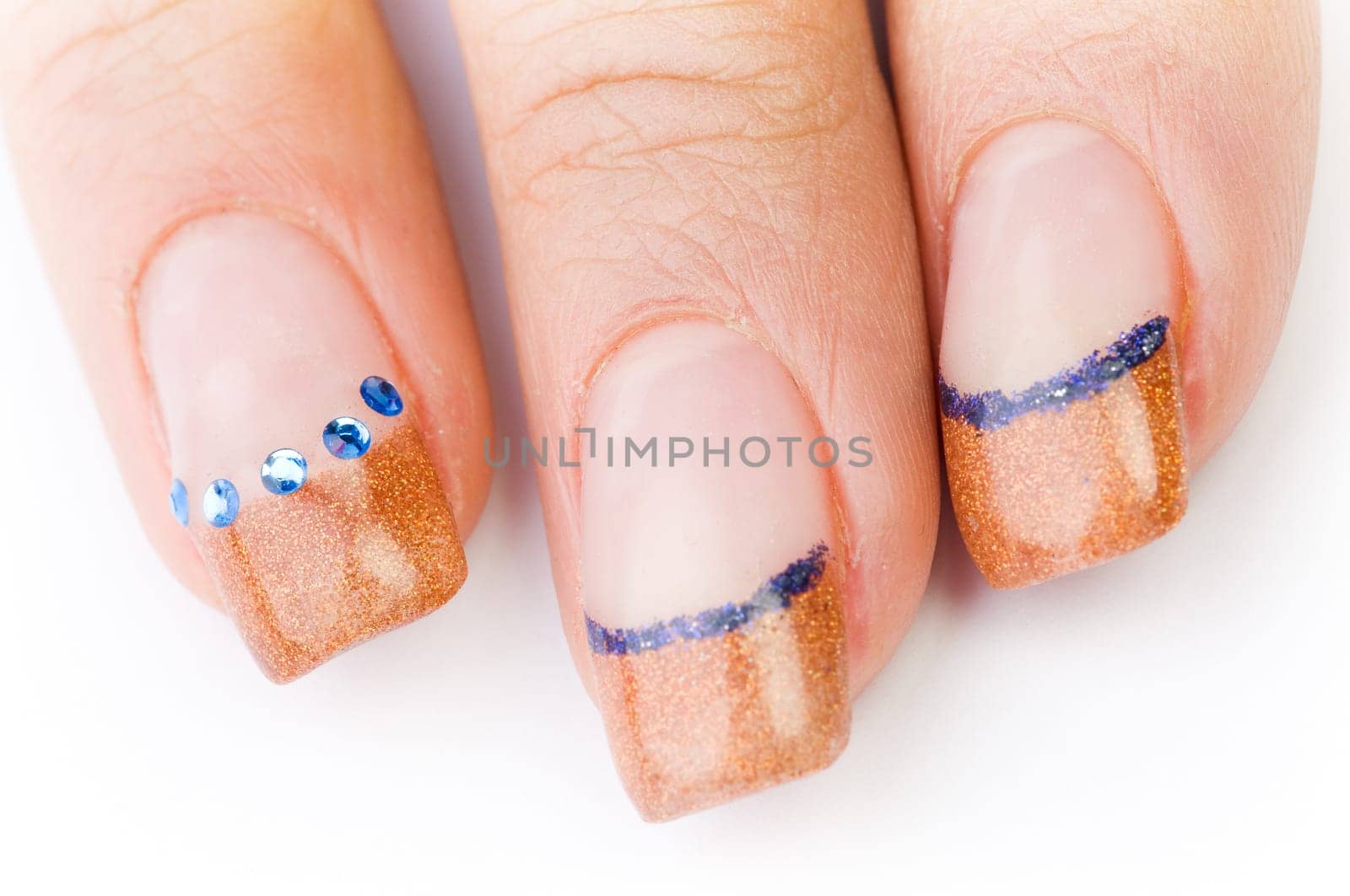 Beautiful female well-groomed colorful fingernails against white background