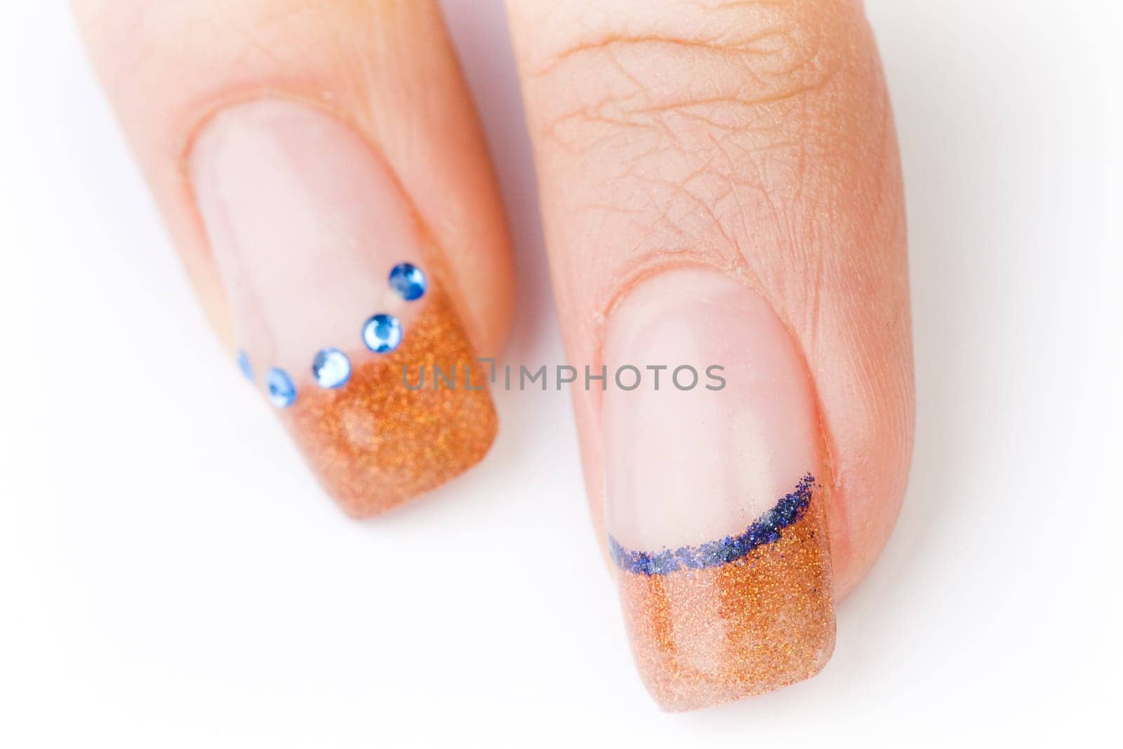 Beautiful female well-groomed colorful fingernails against white background