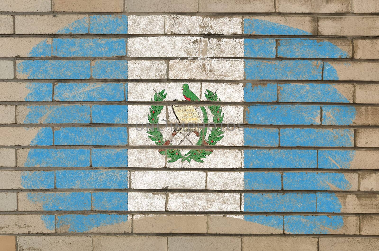 Chalky guatemalan flag painted with color chalk on grunge old brick wall