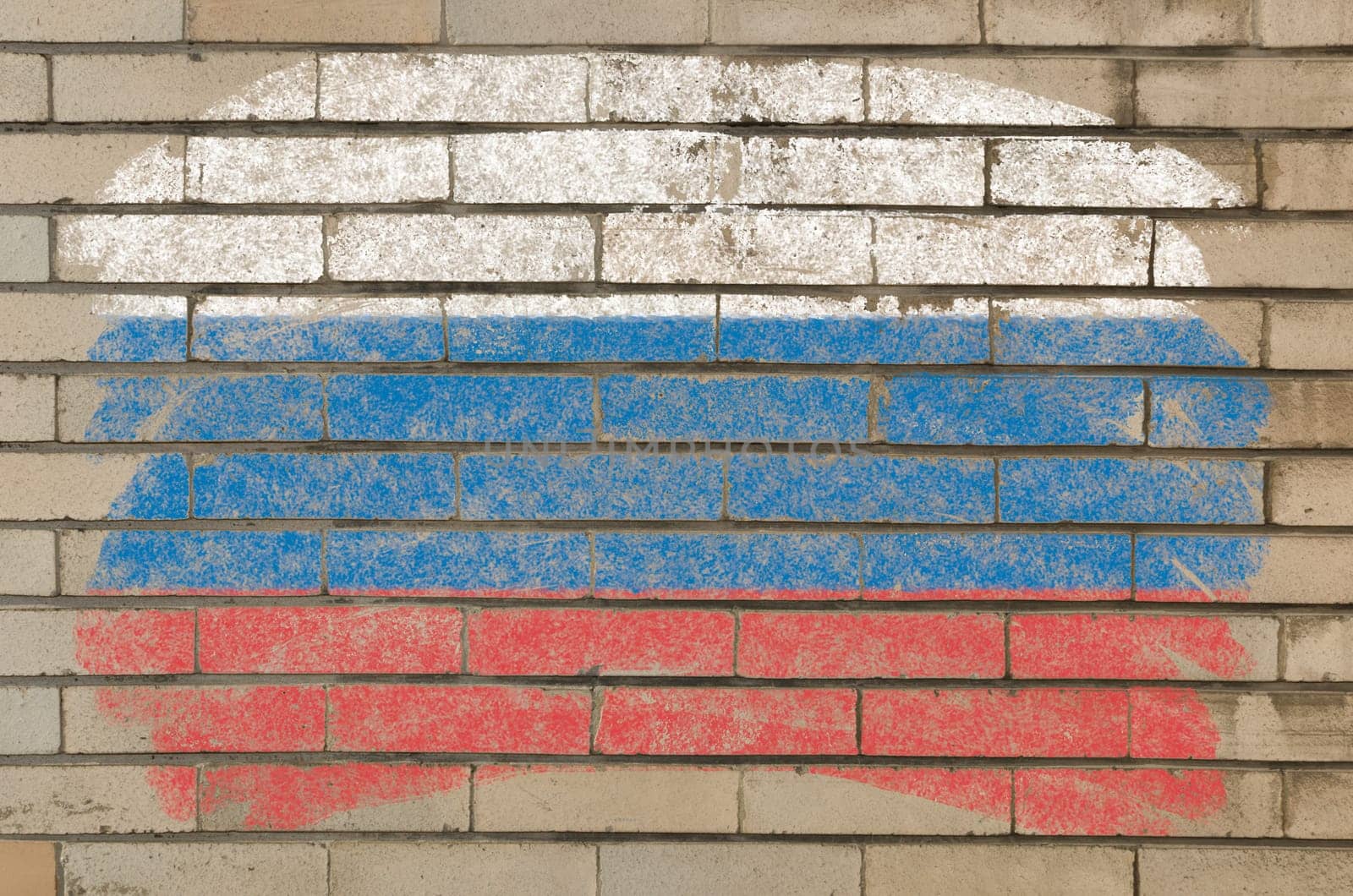 Chalky russian flag painted with color chalk on grunge old brick wall