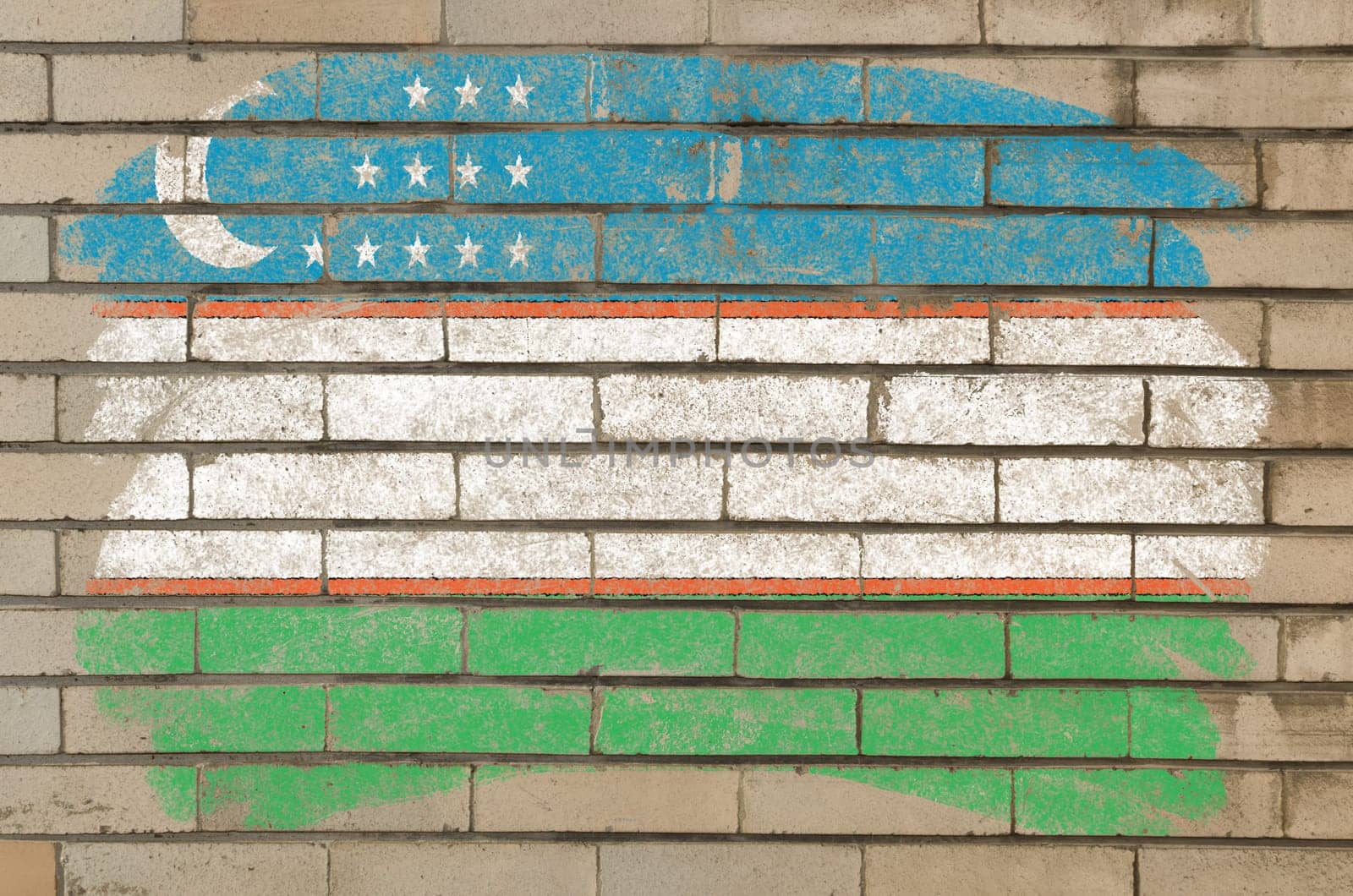 Chalky uzbekistan flag painted with color chalk on grunge old brick wall
