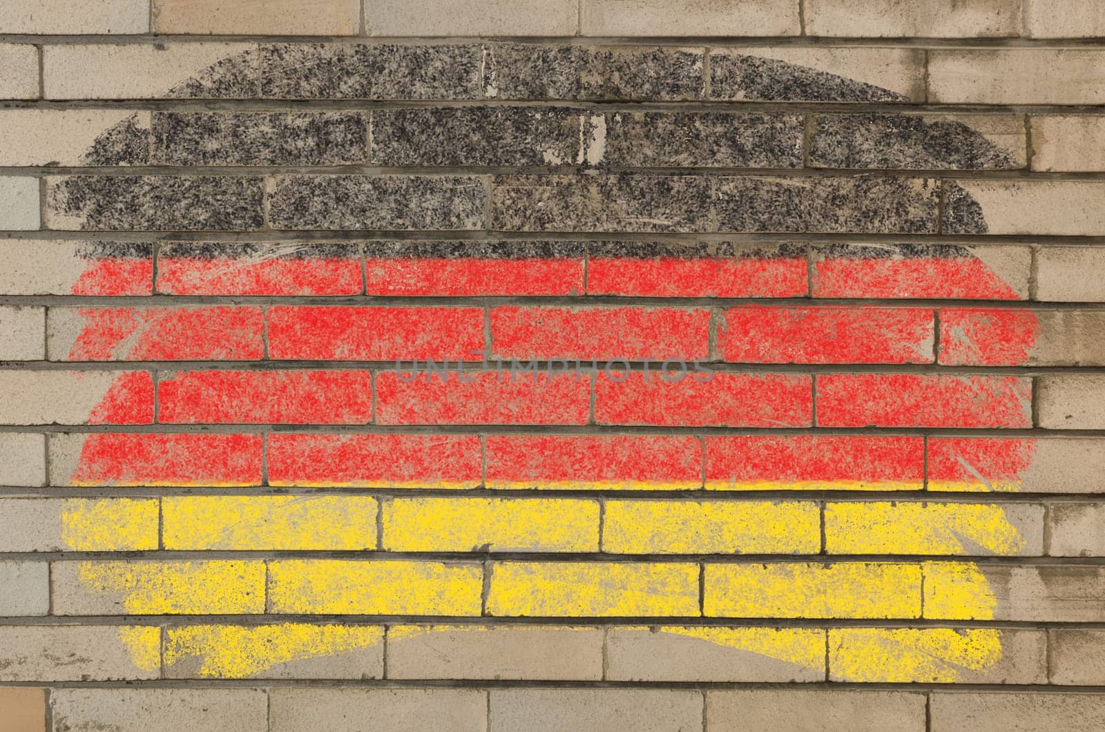 Chalky german flag painted with color chalk on grunge old brick wall