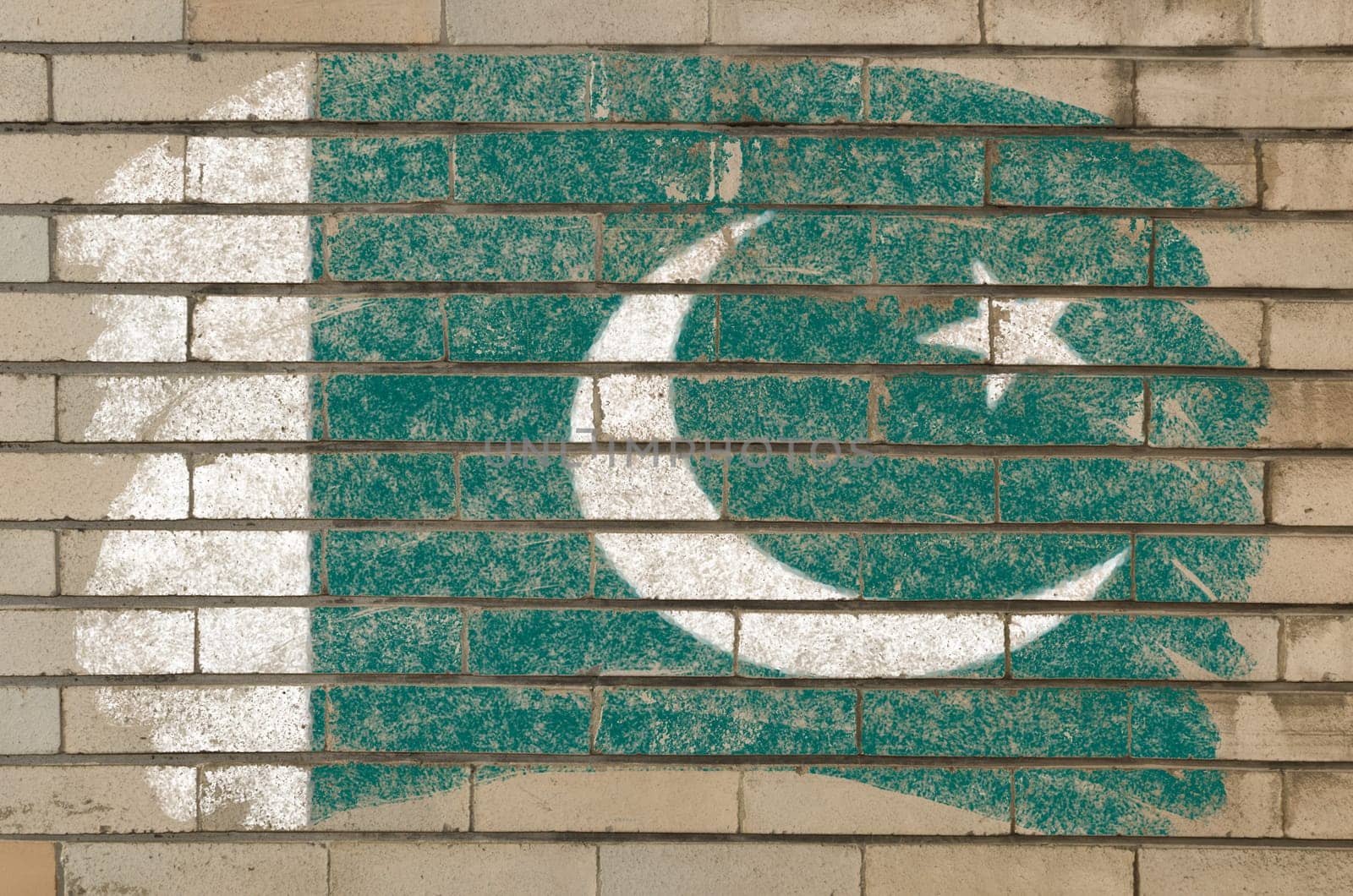 Chalky pakistan flag painted with color chalk on grunge old brick wall