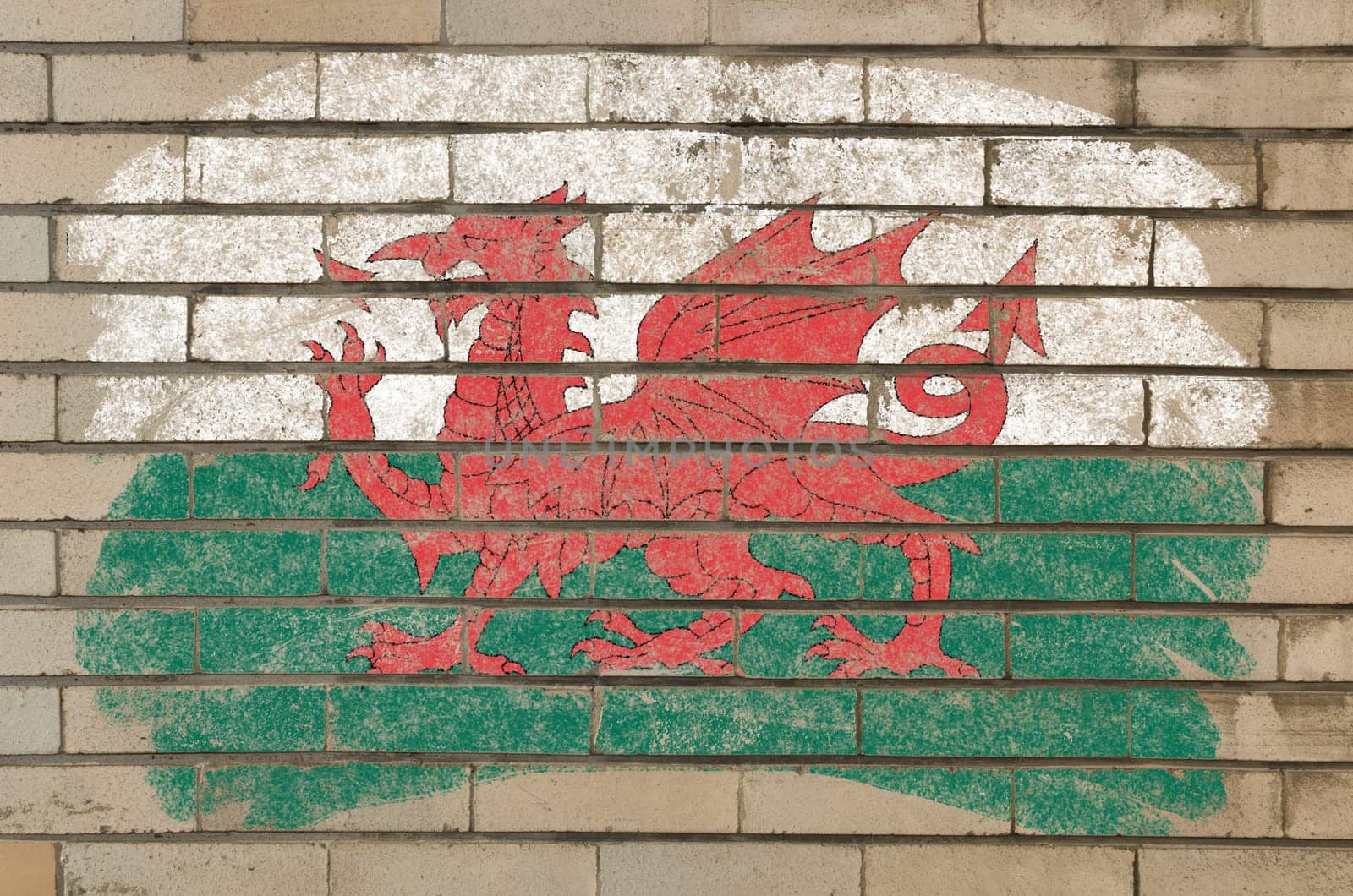 Chalky welsh flag painted with color chalk on grunge old brick wall