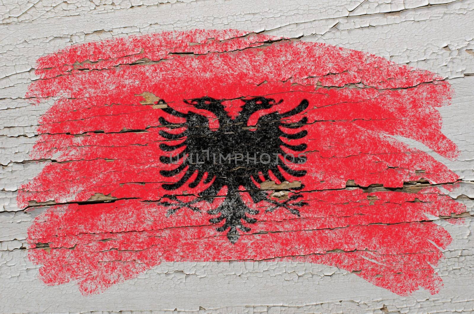 Chalky albanian flag painted with color chalk on grunge wooden texture