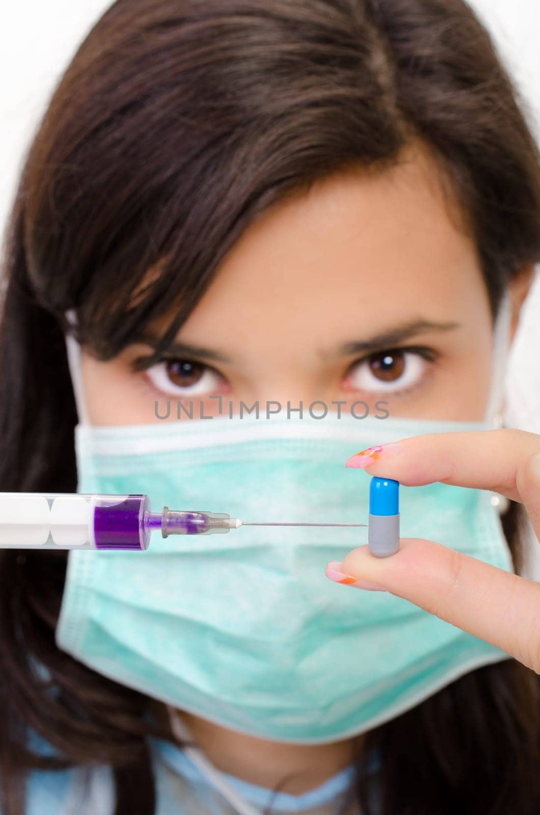 An attractive pharmacist woman inject a liquid in a pill