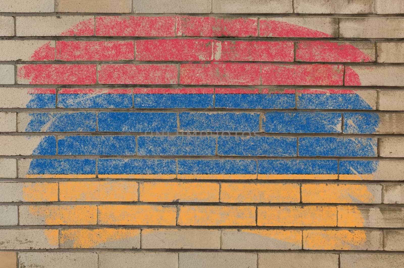 Chalky armenian flag painted with color chalk on grunge old brick wall