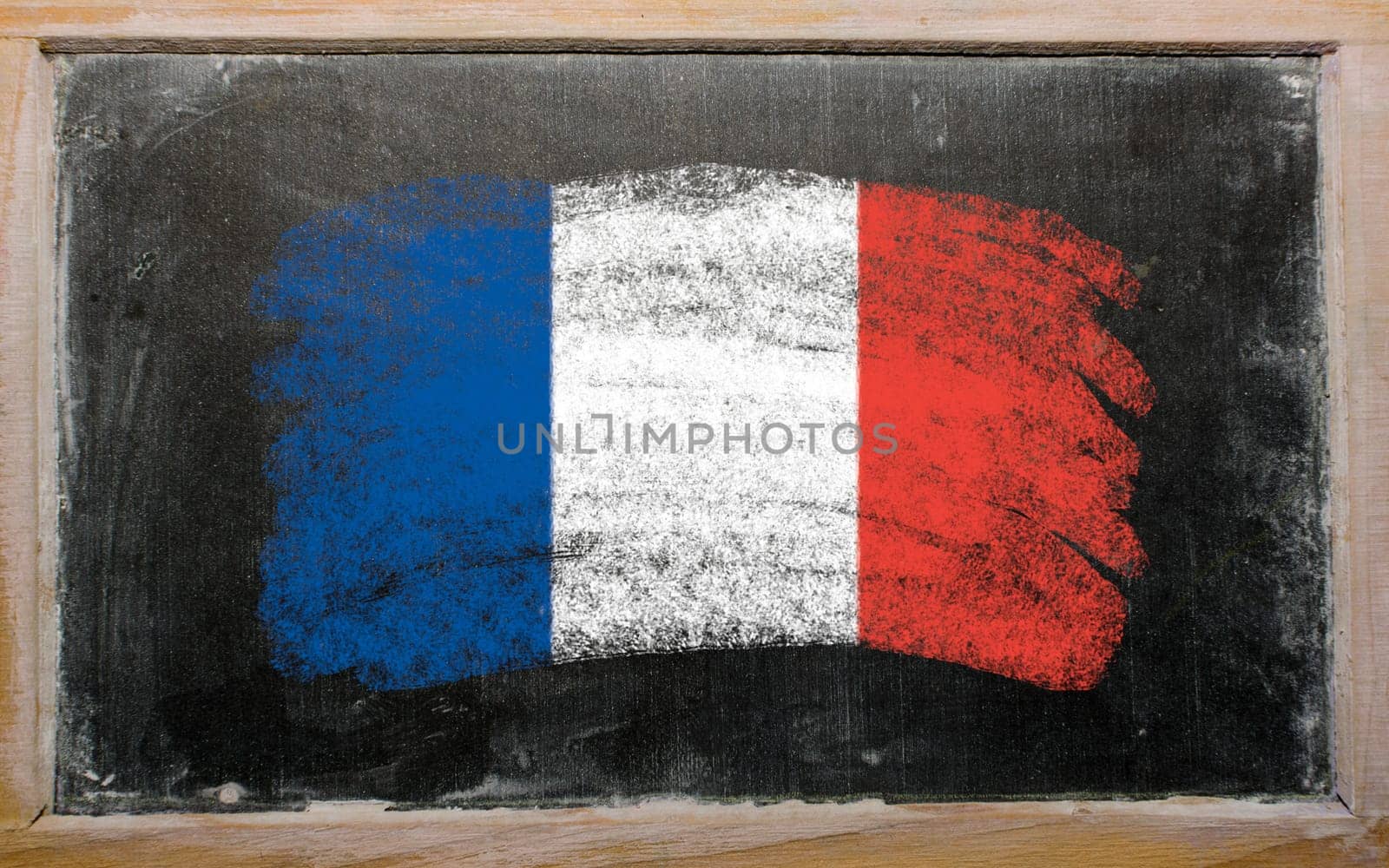 Chalky french flag painted with color chalk on old blackboard