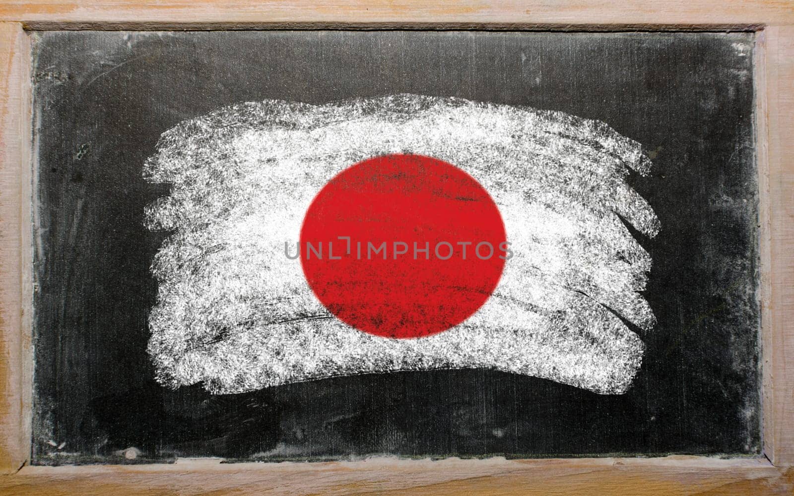 Chalky japanese flag painted with color chalk on old blackboard
