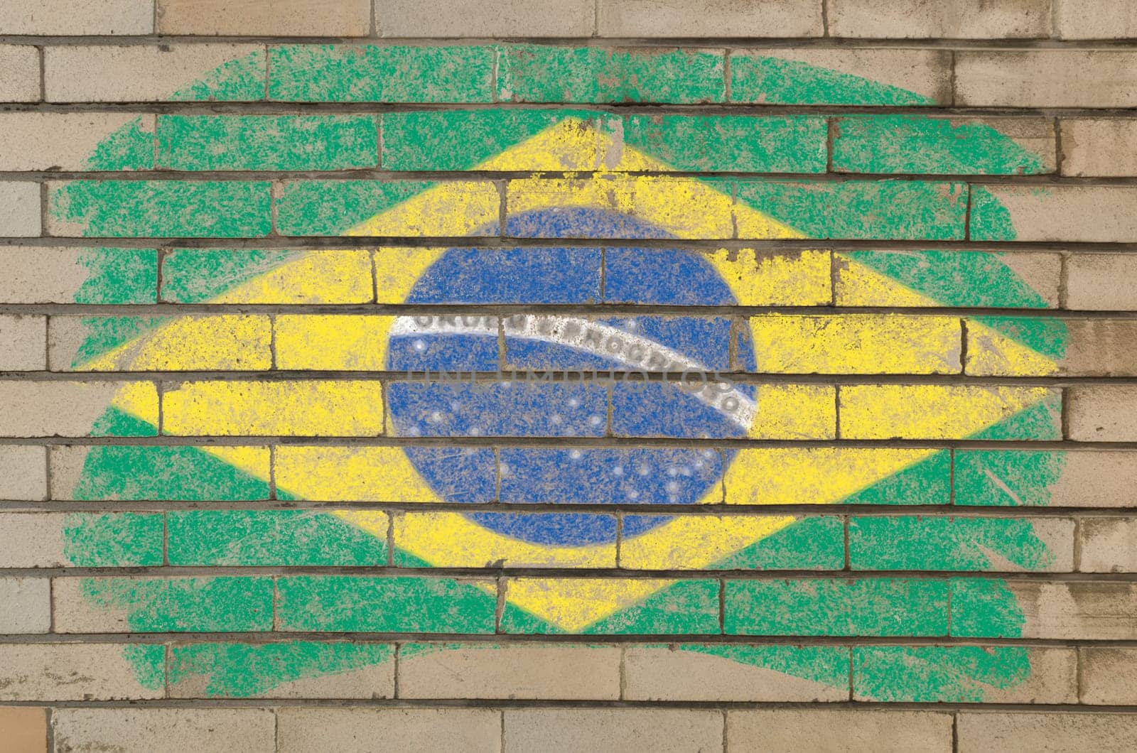 Chalky brazilian flag painted with color chalk on grunge old brick wall