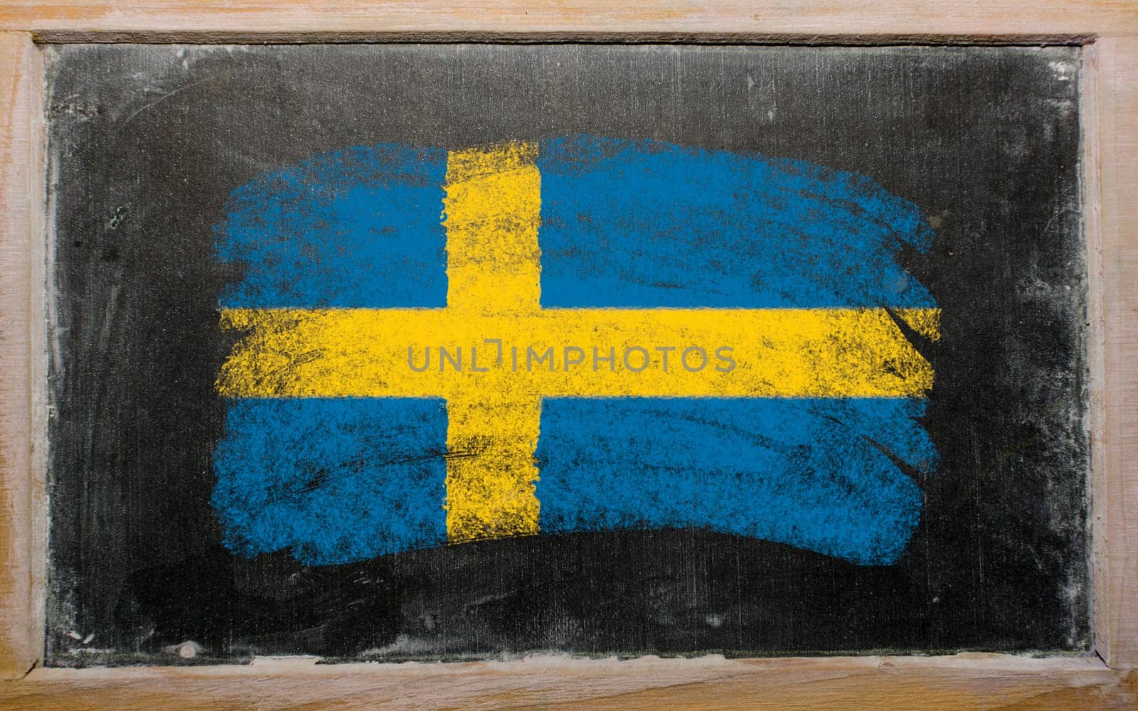 Chalky Swedish flag painted with color chalk on old blackboard