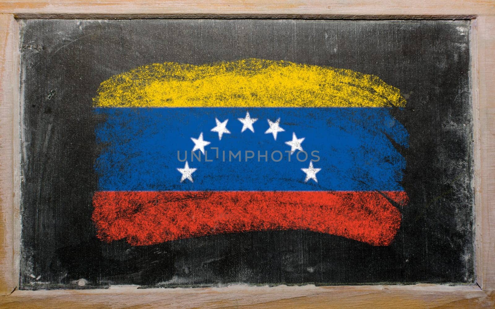 Chalky venezuelan flag painted with color chalk on old blackboard