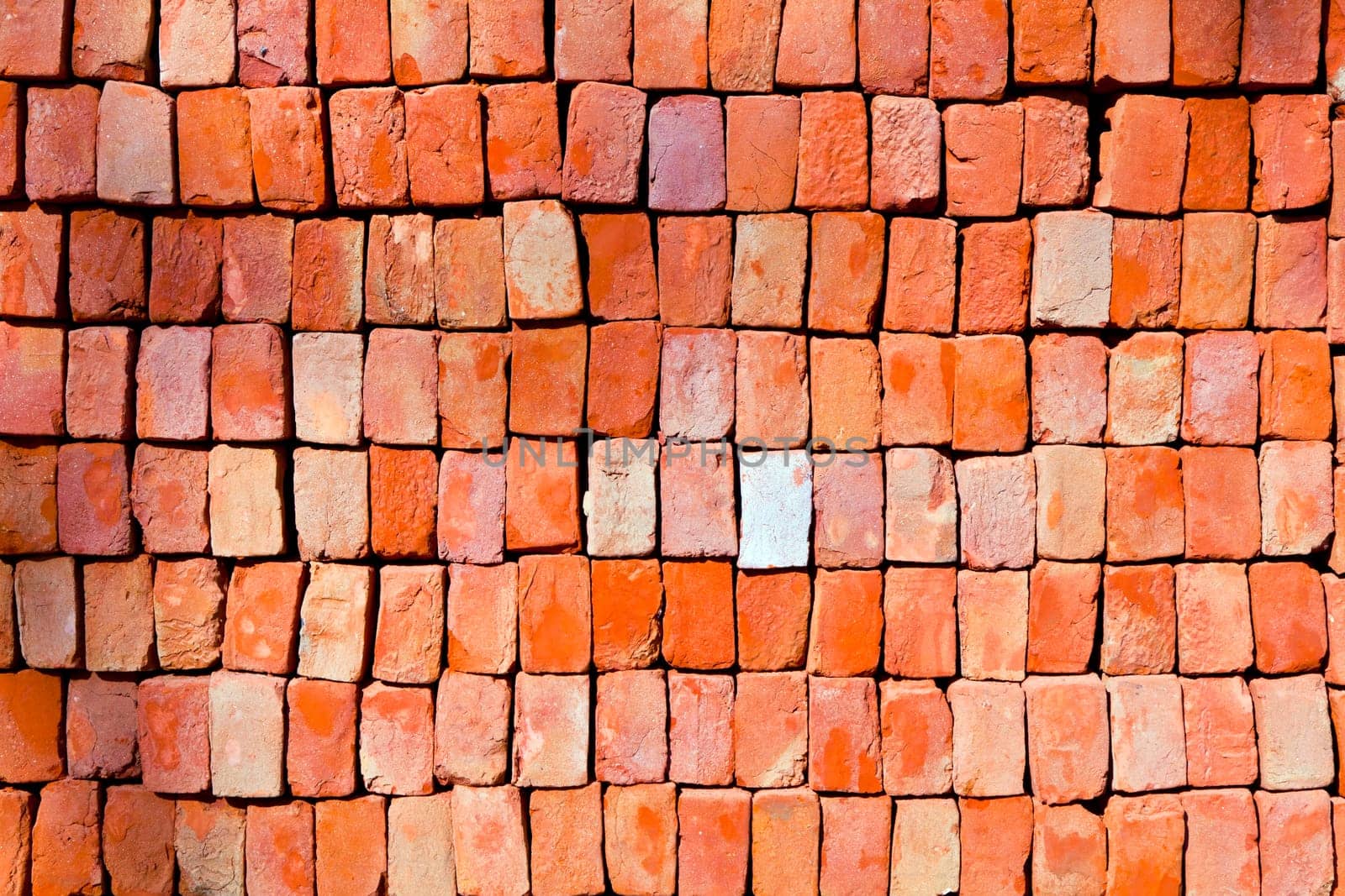 red stapled bricks give a harmonic pattern in the sun