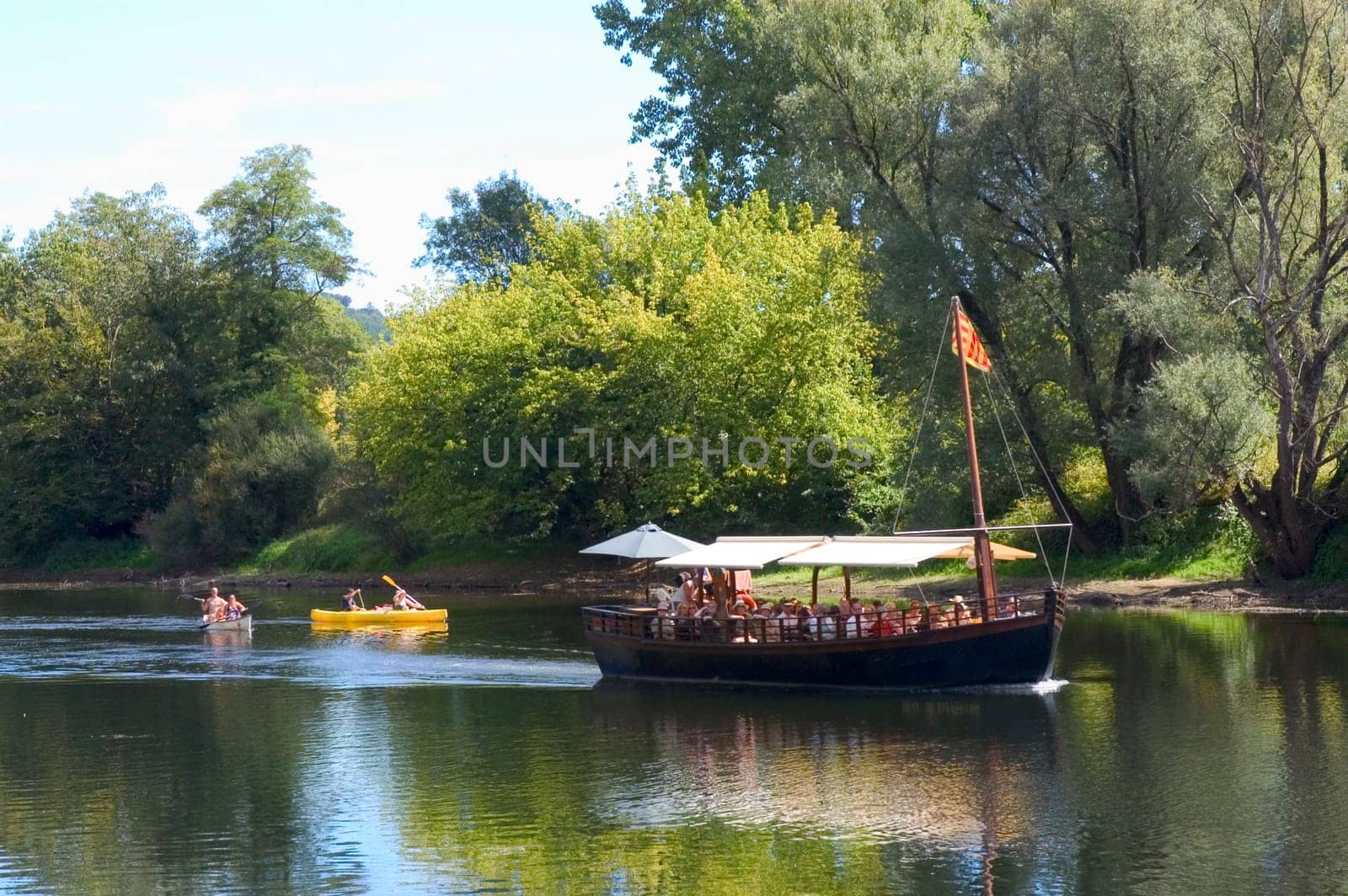 A walk in boat on the Dordogne on board traditional boatscalled barges or gabarres