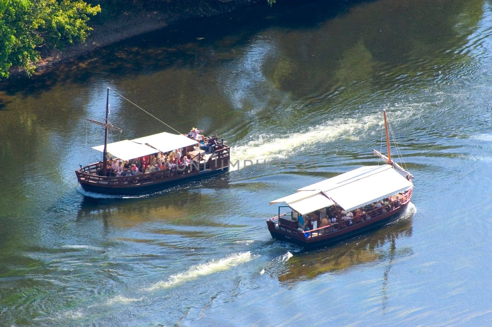 A walk in boat on the Dordogne on board traditional boatscalled barges or gabarres