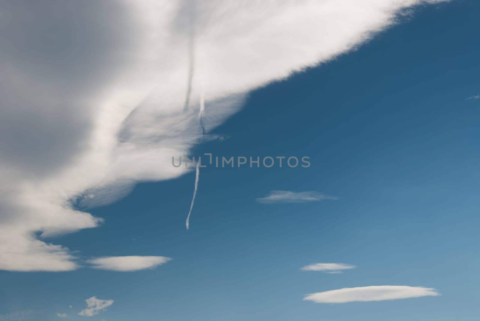 shadow of a cloud with the wake of a plane