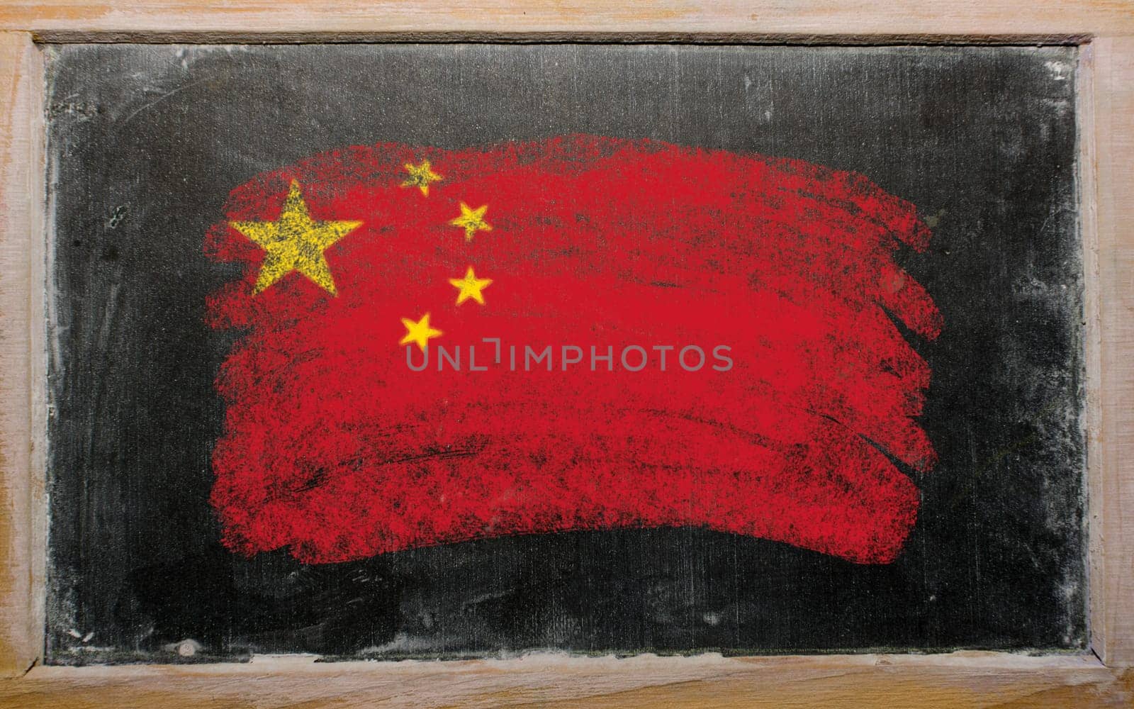 Chalky chinese flag painted with color chalk on old blackboard