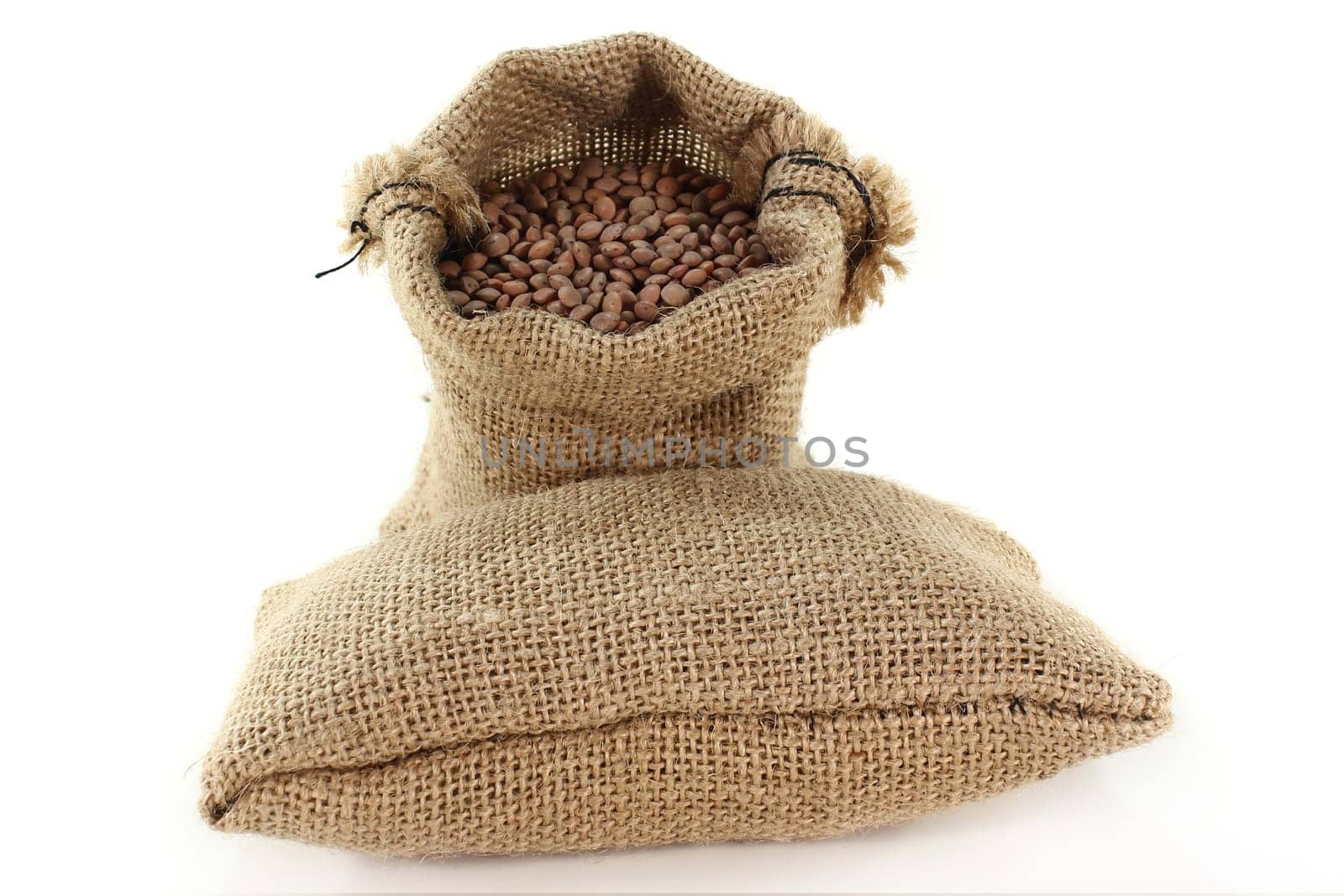 a sack filled with mountain lentils against a light background