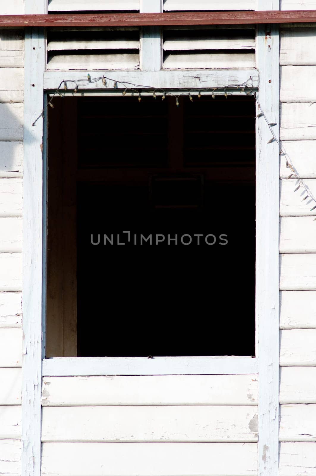 a window of a abandoned wooden house.