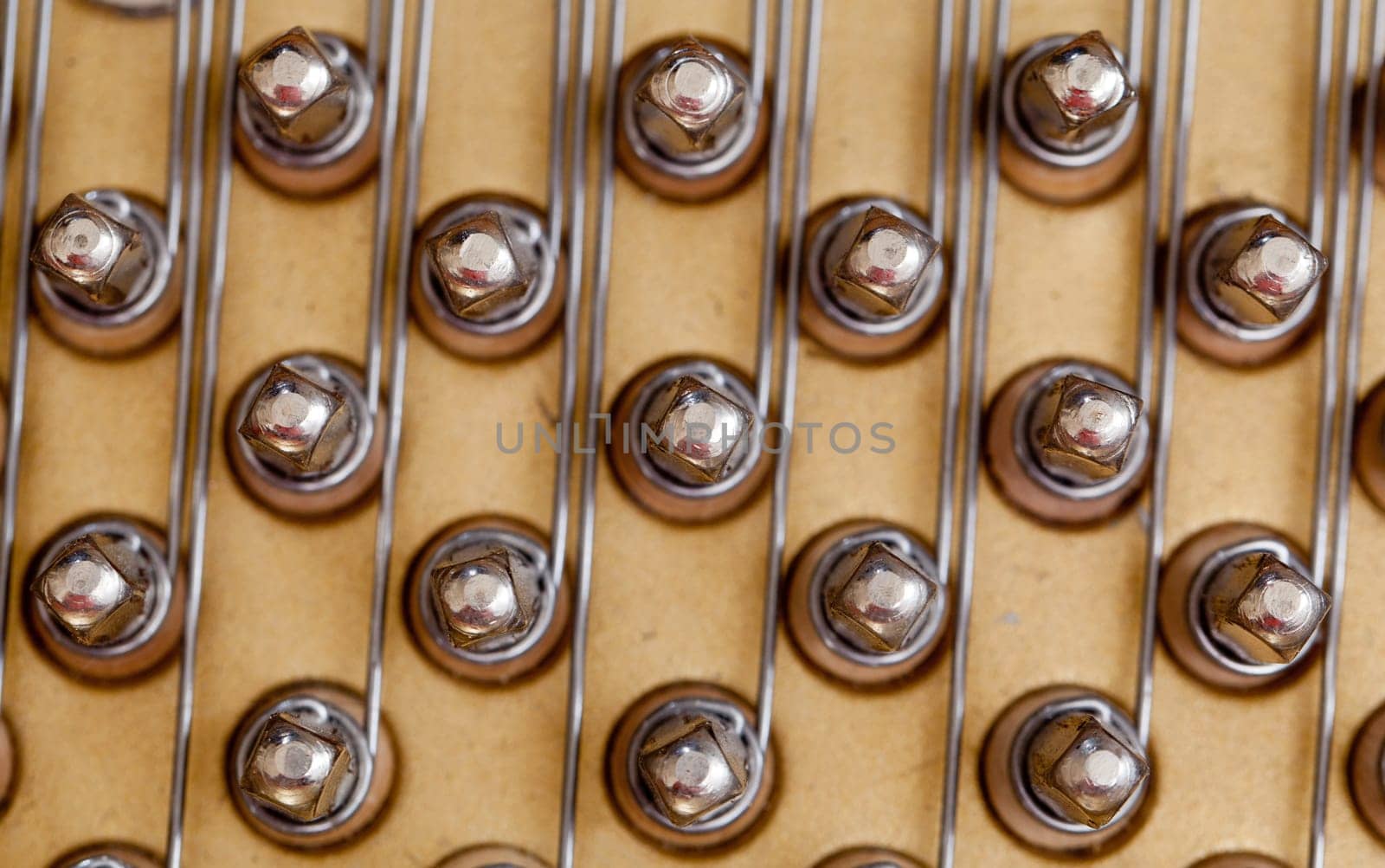 Close up image of interior of grand piano showing strings and structure