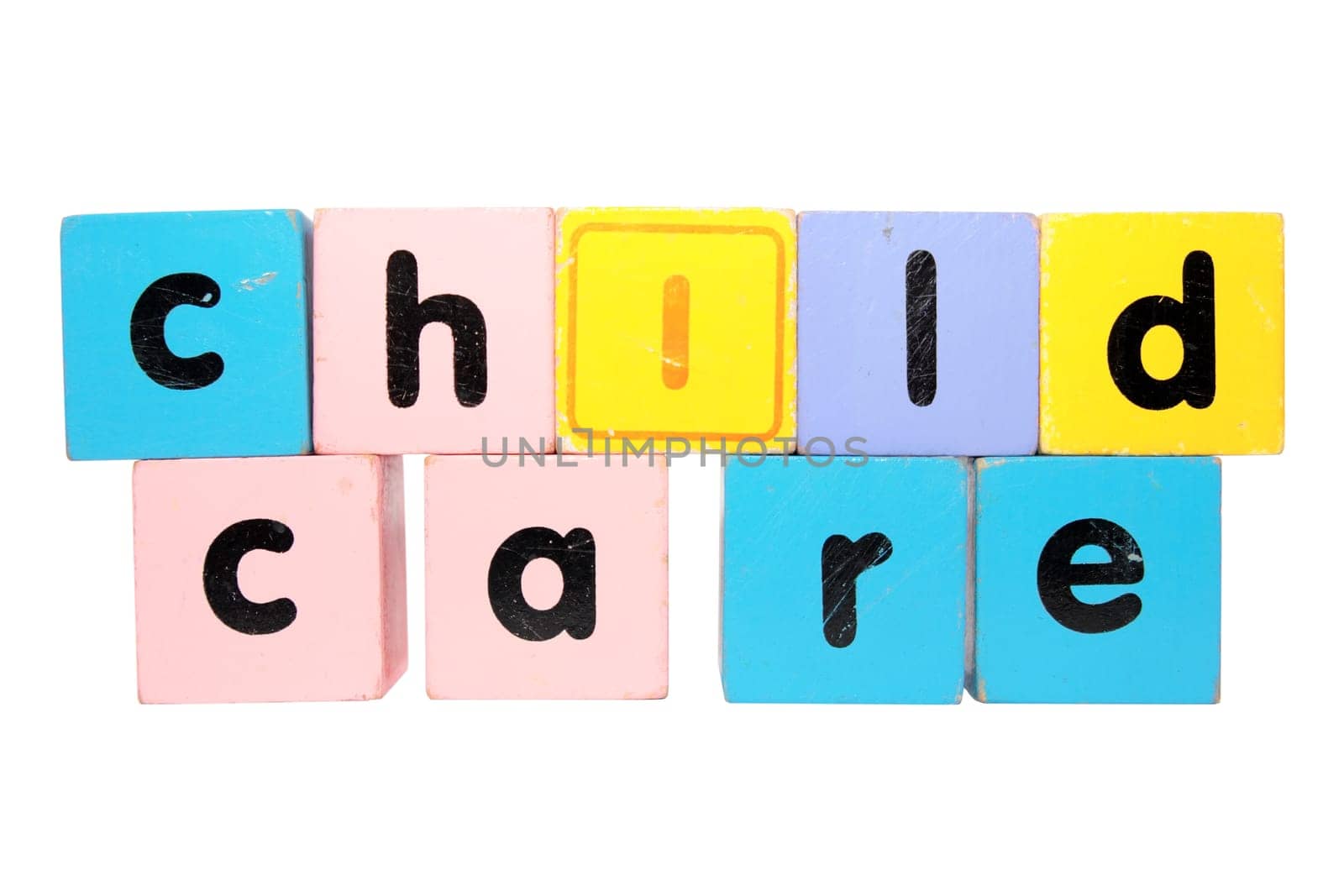 assorted childrens toy letter building blocks against a white background that spell childcare with clipping path