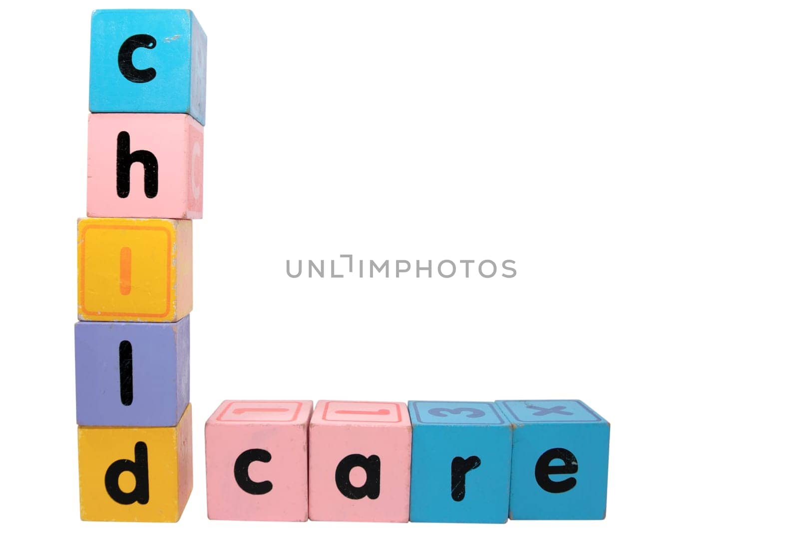 assorted childrens toy letter building blocks against a white background that spell childcare with clipping path