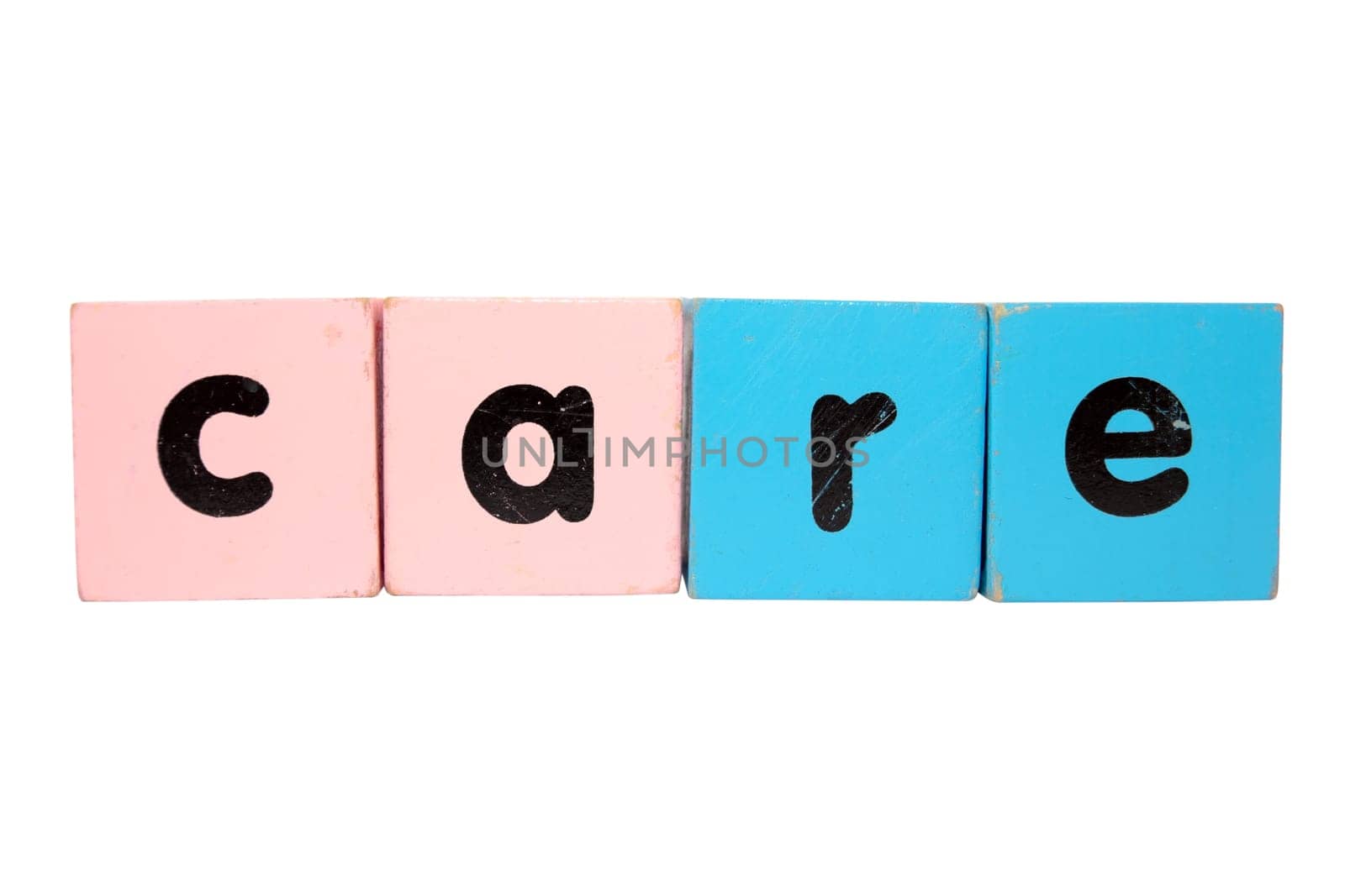 assorted childrens toy letter building blocks against a white background that spell care with clipping path