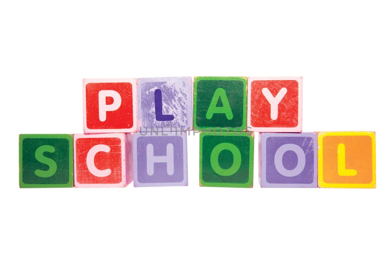 assorted childrens toy letter building blocks against a white background that spell playschool with clipping path