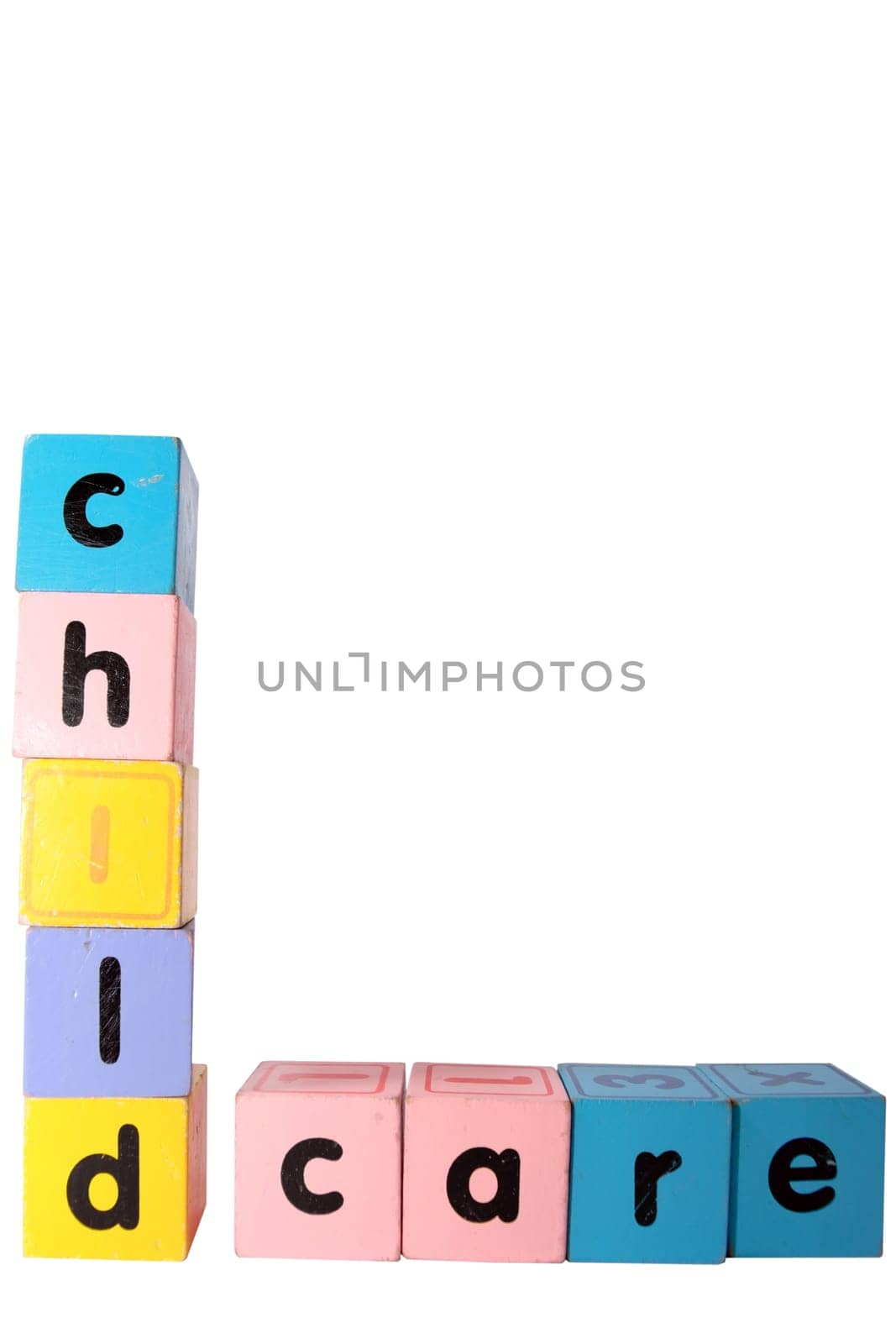 assorted childrens toy letter building blocks against a white background that spell childcare with clipping path