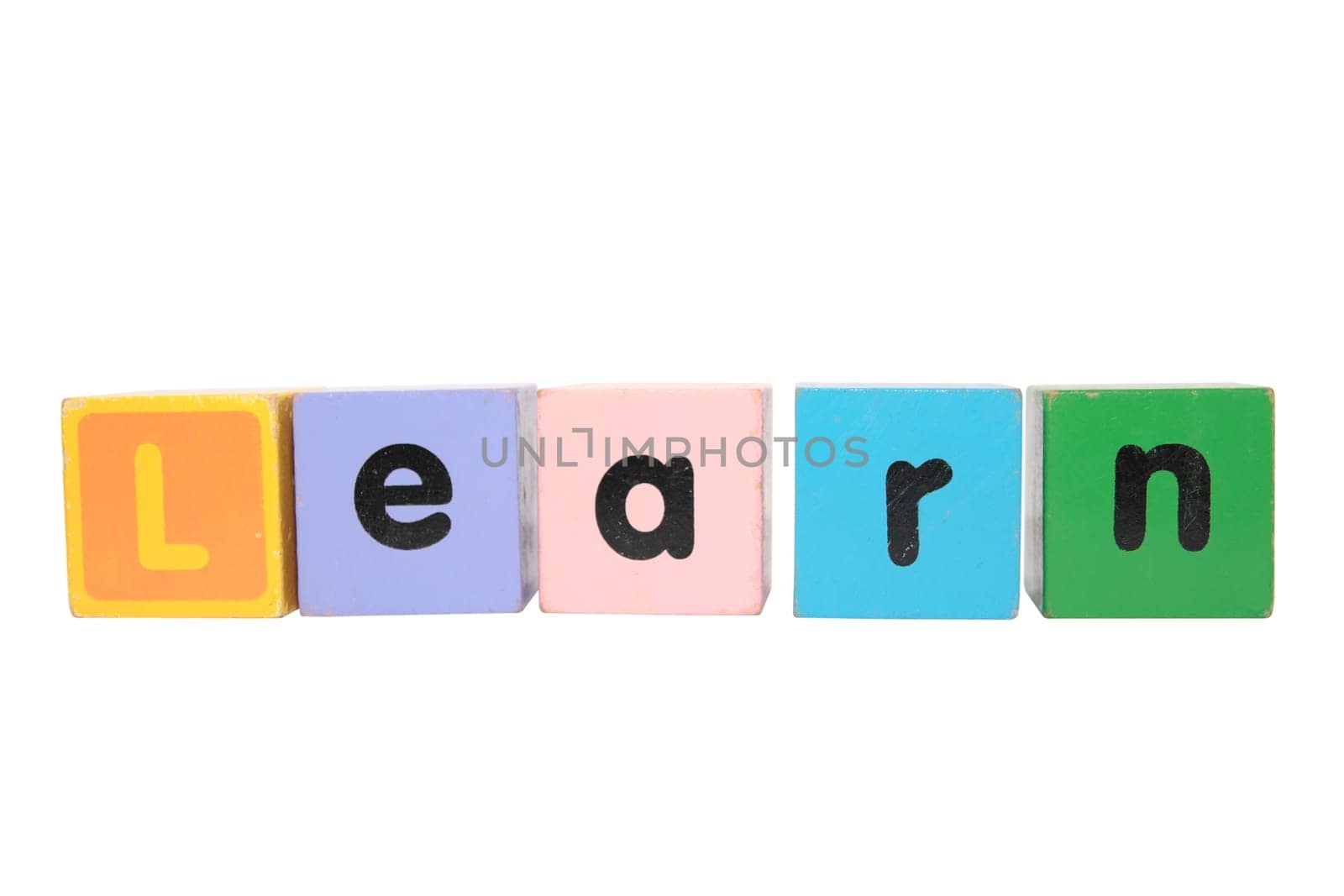 assorted childrens toy letter building blocks against a white background that spell learn with clipping path
