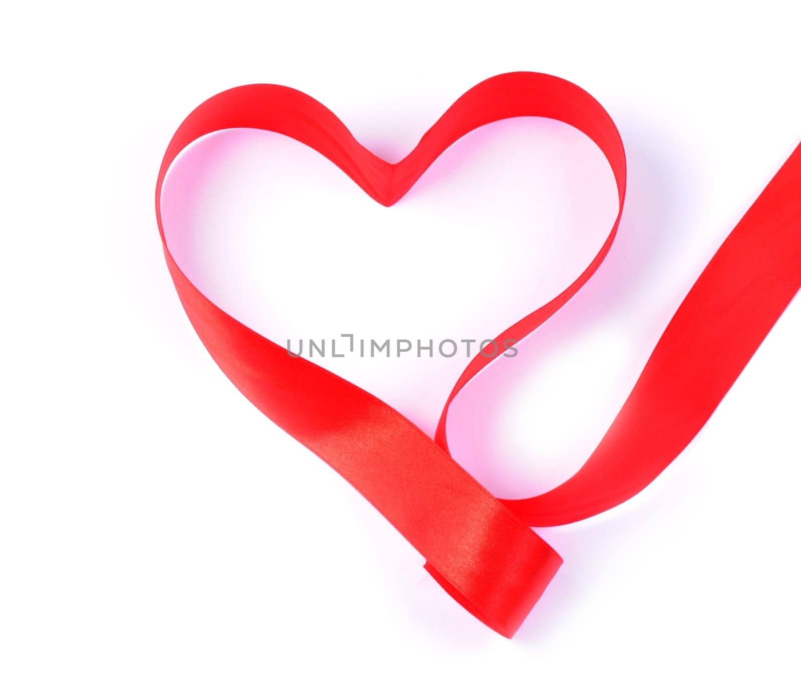 Close-up of a ribbon made red hearth with copy space.