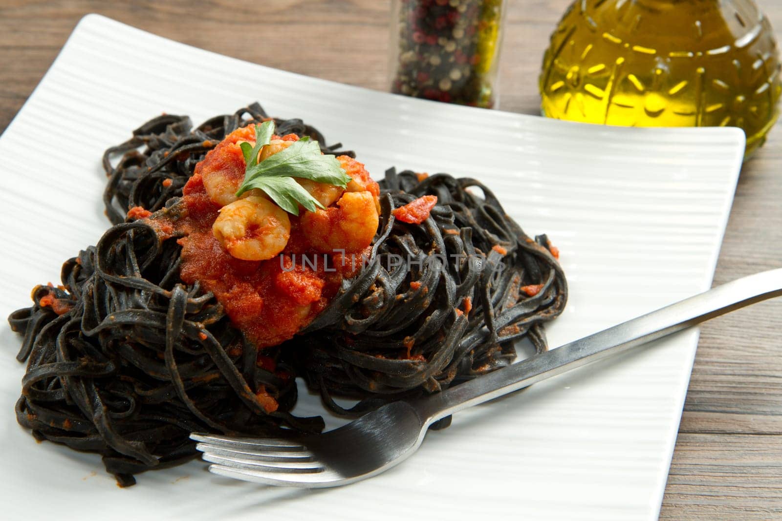 black pasta  with tomatoes sauce and shrimp