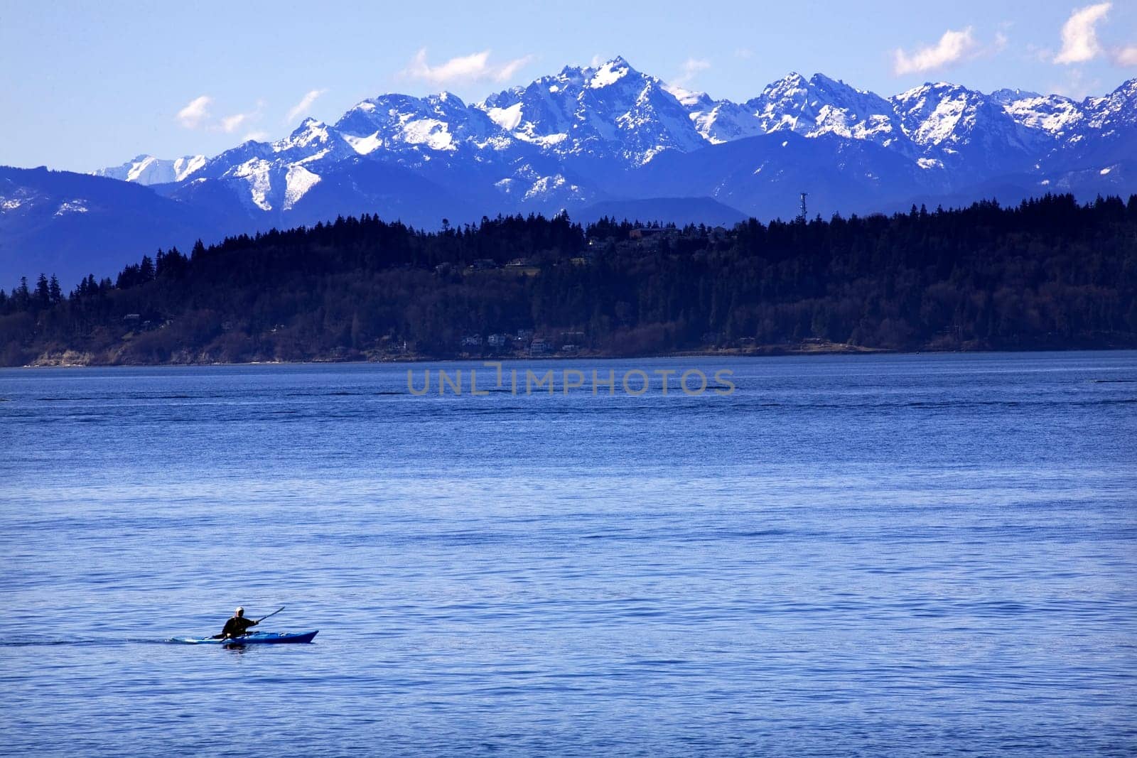 Kayak, Kayaking, on Puget Sound with Snowy Olympic Mountains in background, Edmonds, Snohomish County, Washington  Resubmit--In response to comments from reviewer have further processed image to reduce noise and sharpen focus.