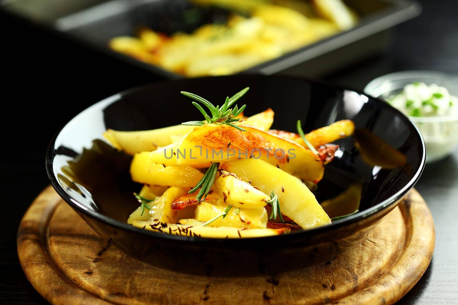 Baked potatoes with cheese dip and rosemary
