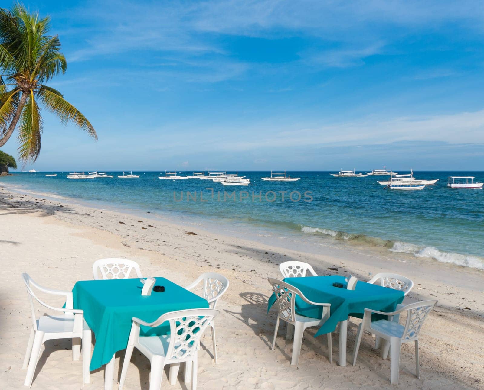 dining tables on a tropical beach