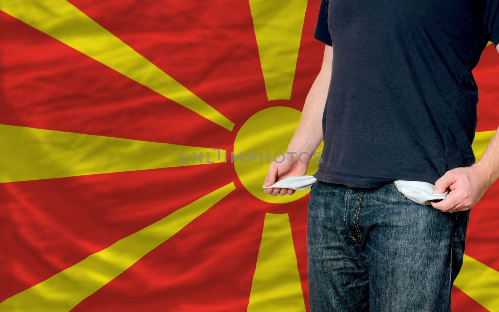 poor man showing empty pockets in front of macedonia flag
